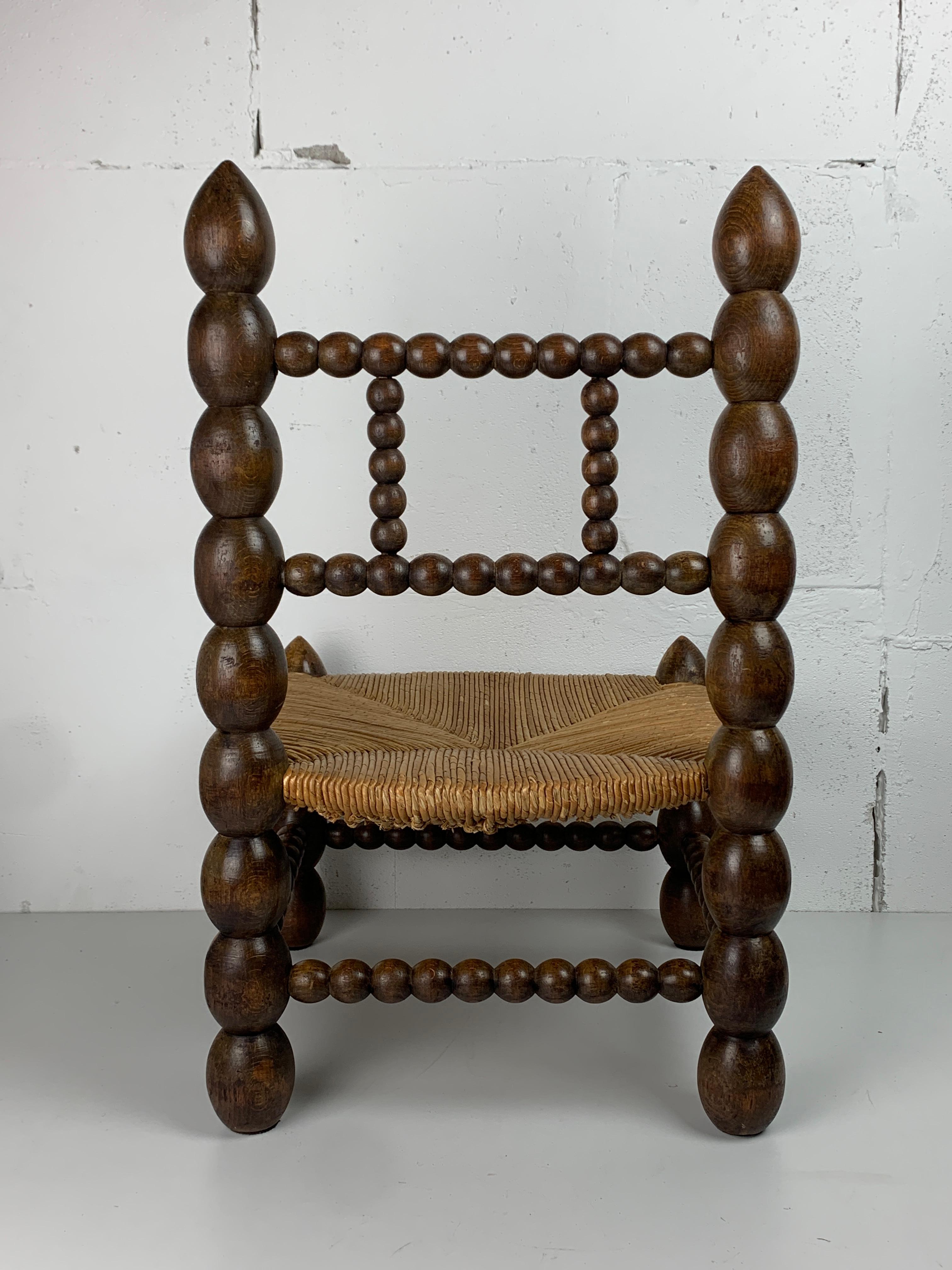 Brutalist wood turned bobbin low rush chair in the style of Charles Dudouyt 4