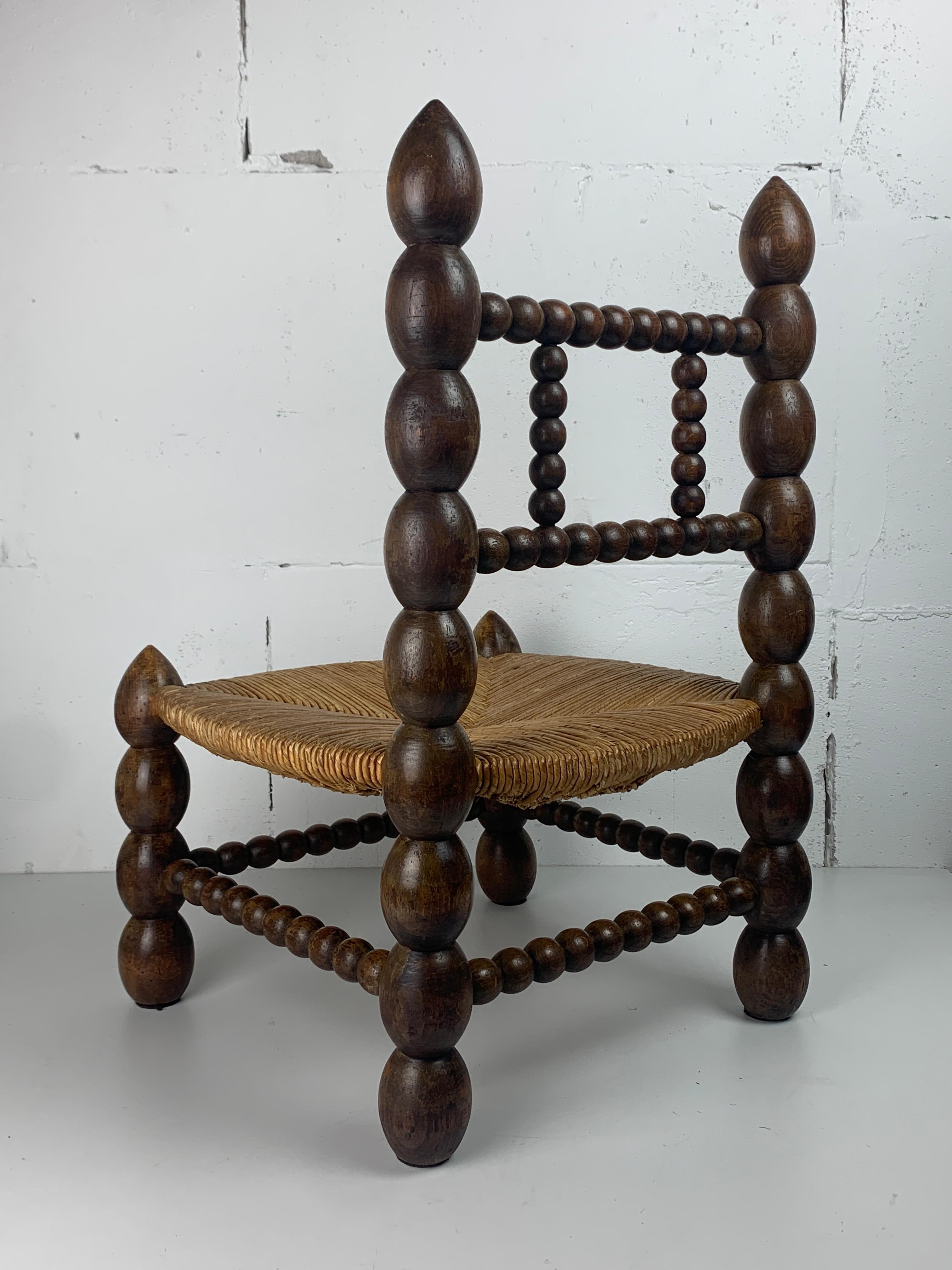 Brutalist wood turned bobbin low rush chair in the style of Charles Dudouyt 5