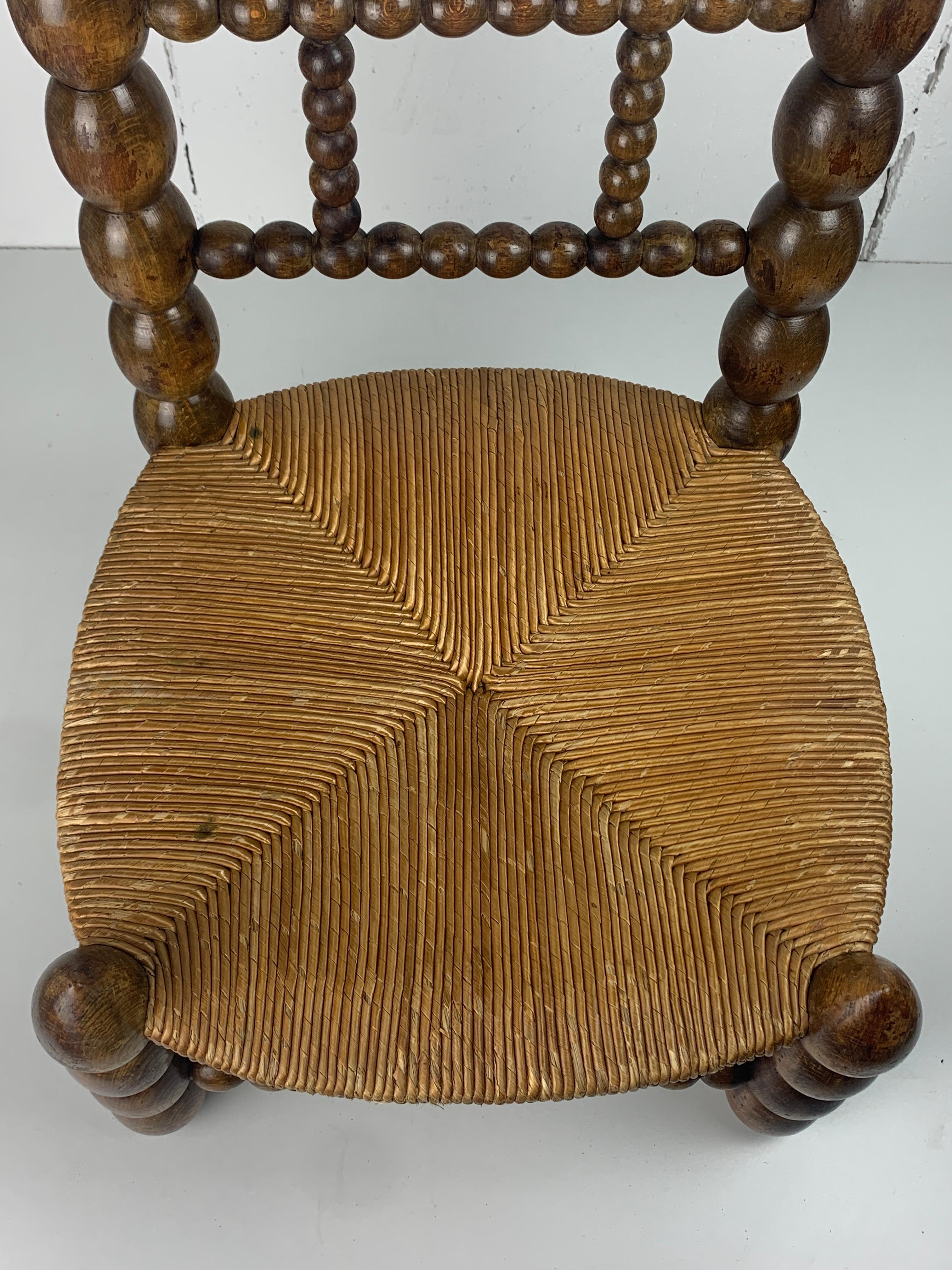 Brutalist wood turned bobbin low rush chair in the style of Charles Dudouyt 9