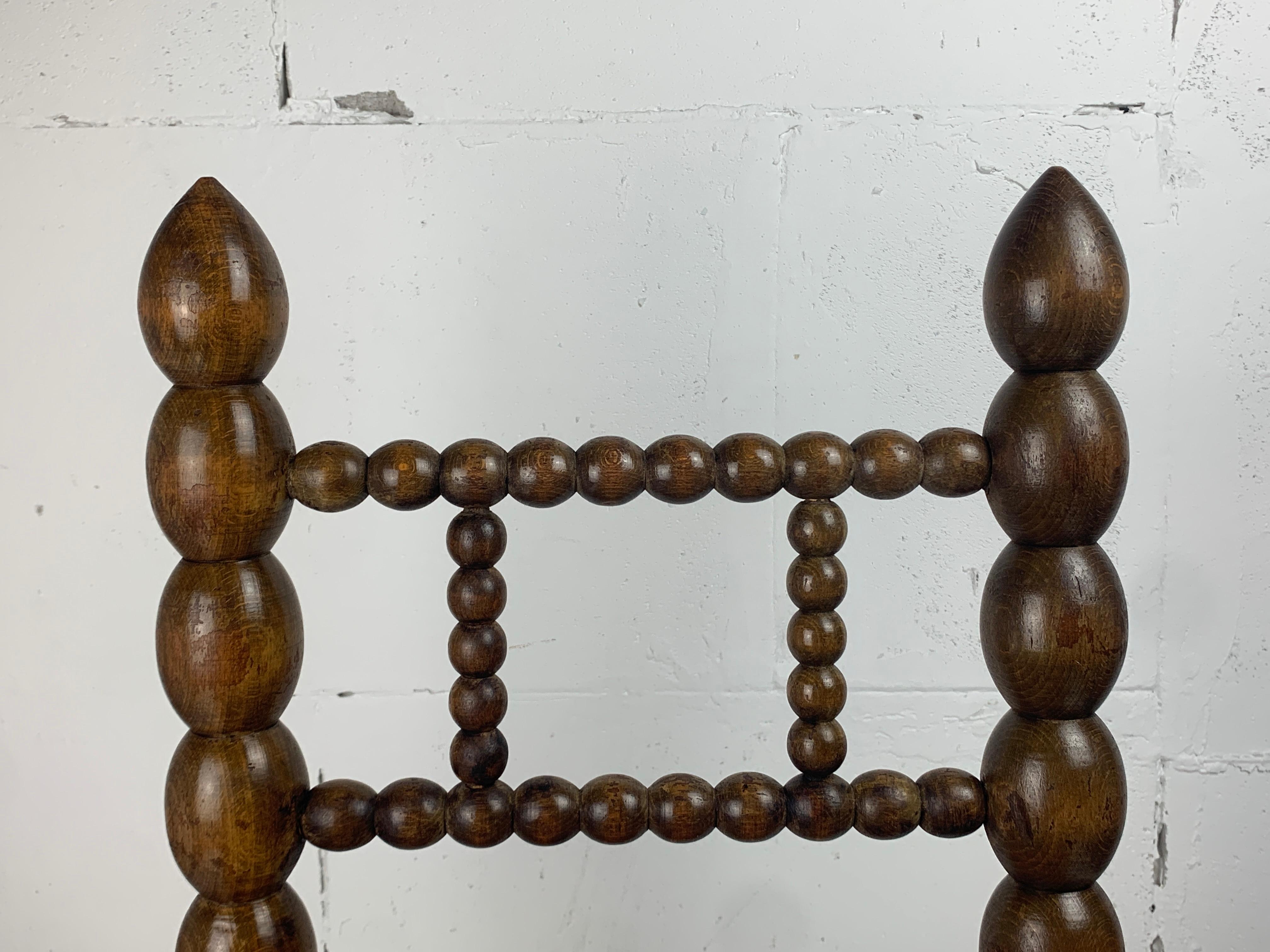 Brutalist wood turned bobbin low rush chair in the style of Charles Dudouyt 10