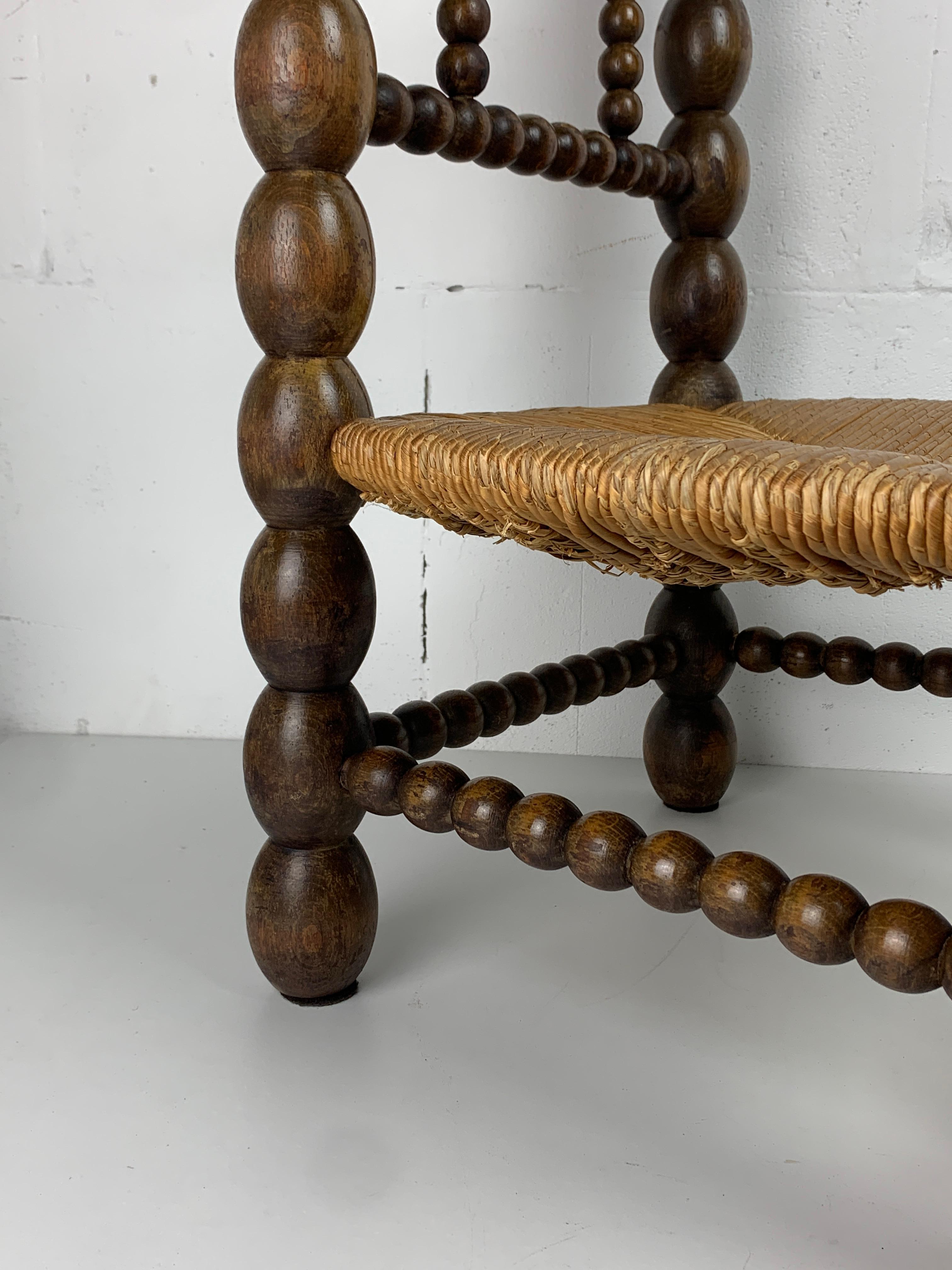 Brutalist wood turned bobbin low rush chair in the style of Charles Dudouyt In Good Condition In Zaandam, NL