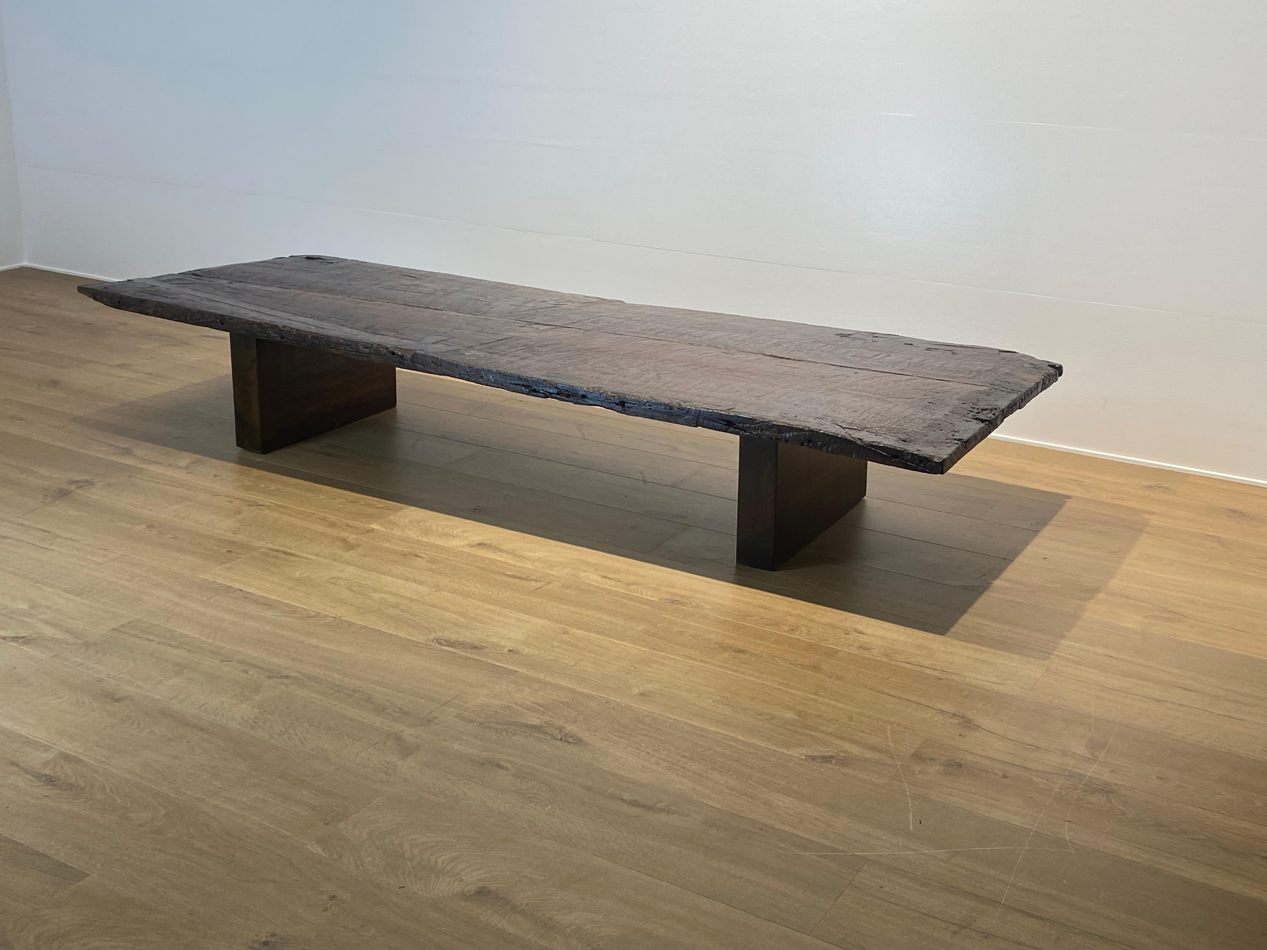 An Brutalist and Antique Sofa Table made out of an 18 th Century Chestnut wooden table top , based on a wooden modern base of an simple design,
the Chestnut top has a very warm colored Patina,
powerful table to decorate, timeless design piece of