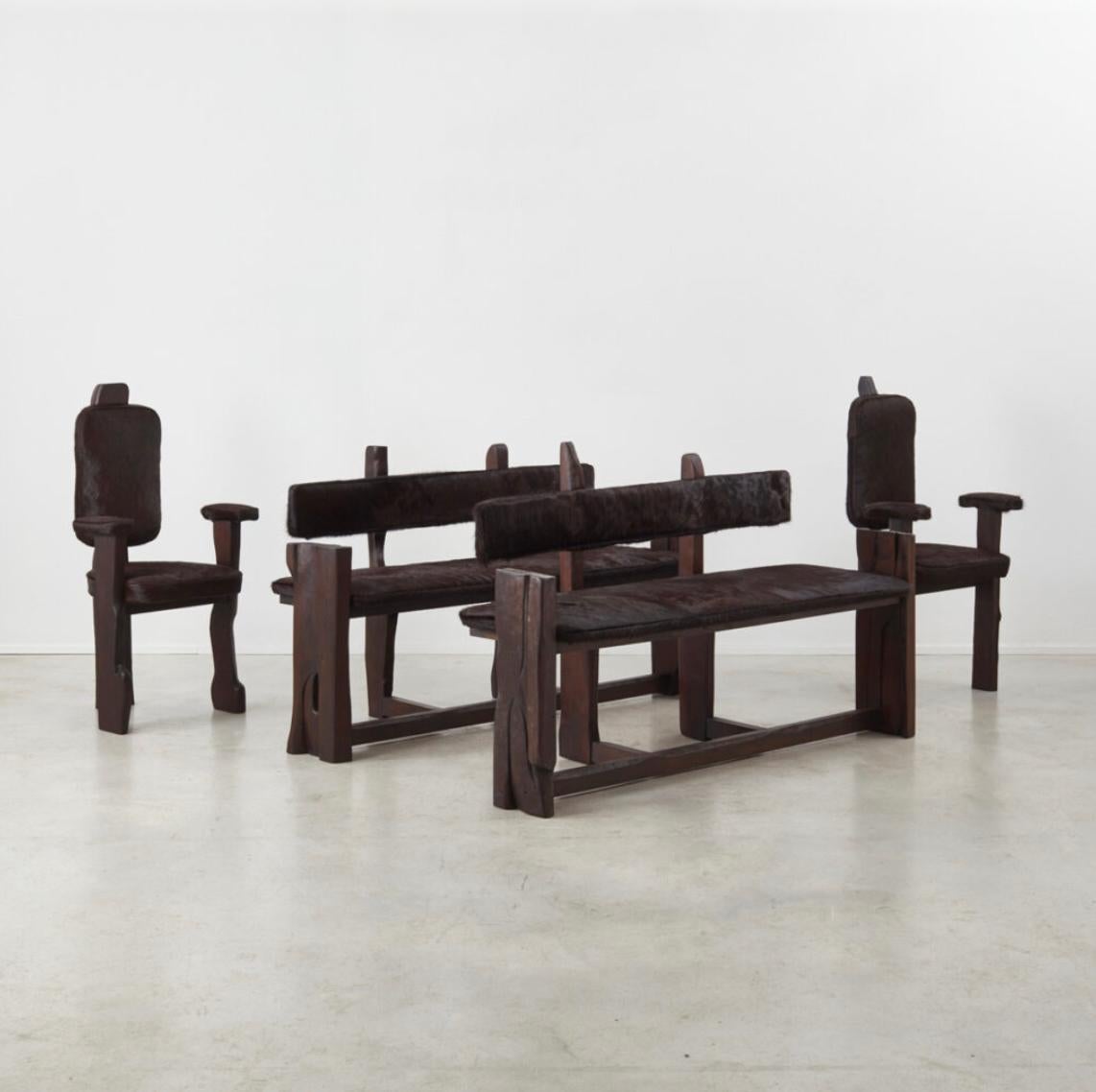 A 1970s French chunky-wood dining seating set, consisting of two benches and two carver chairs in ‘ponyhair’. The construction is rudimentary but incredibly solid, and it expresses a strangely contemporary form. Matches a dark oak refectory table in