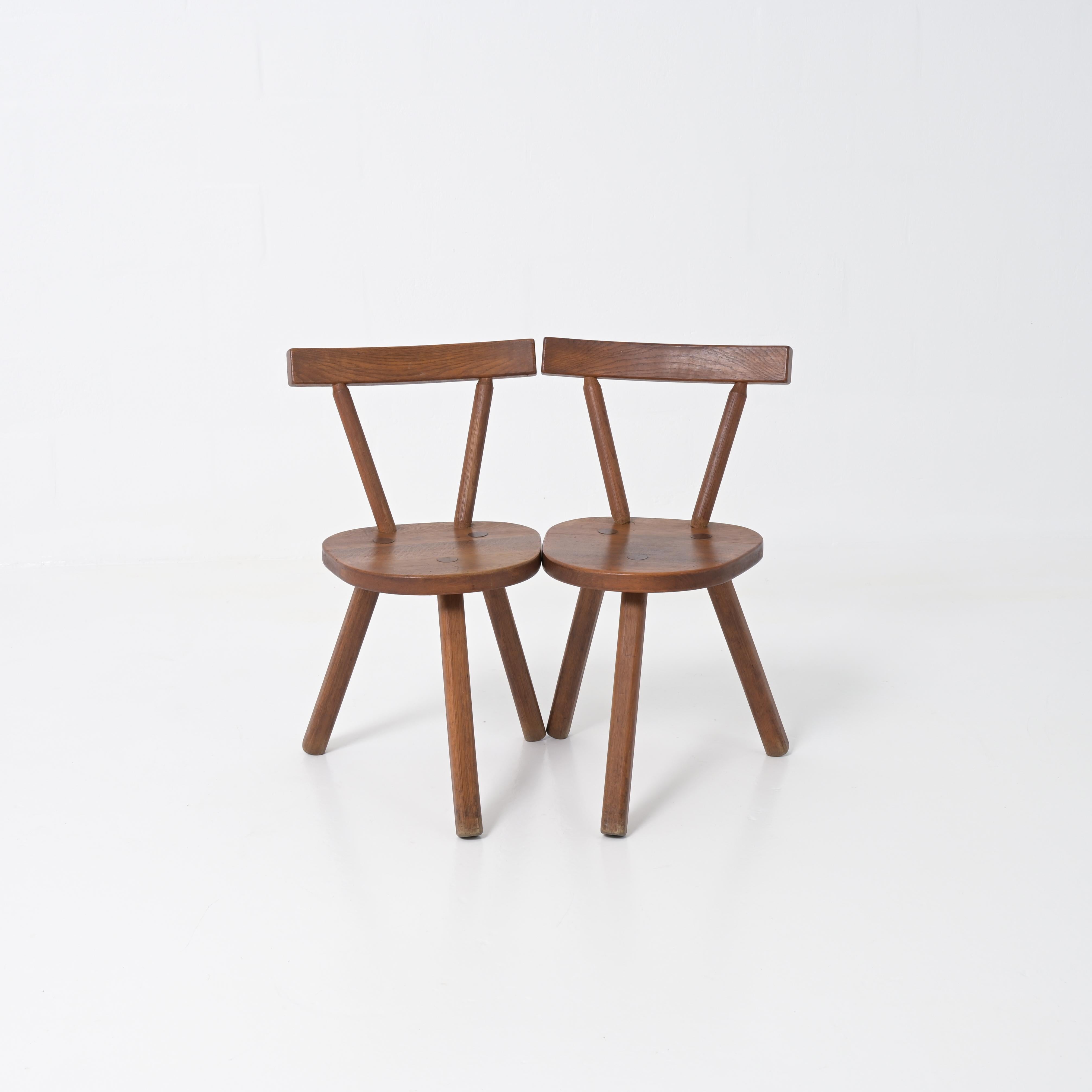 This wooden brutalist chair in the style of Jean touret can be dated in the 70 ties. The three legs are rare and remarkable for this type off chair, they are well made and made out off solid wood. They can be placed anywhere and will give your