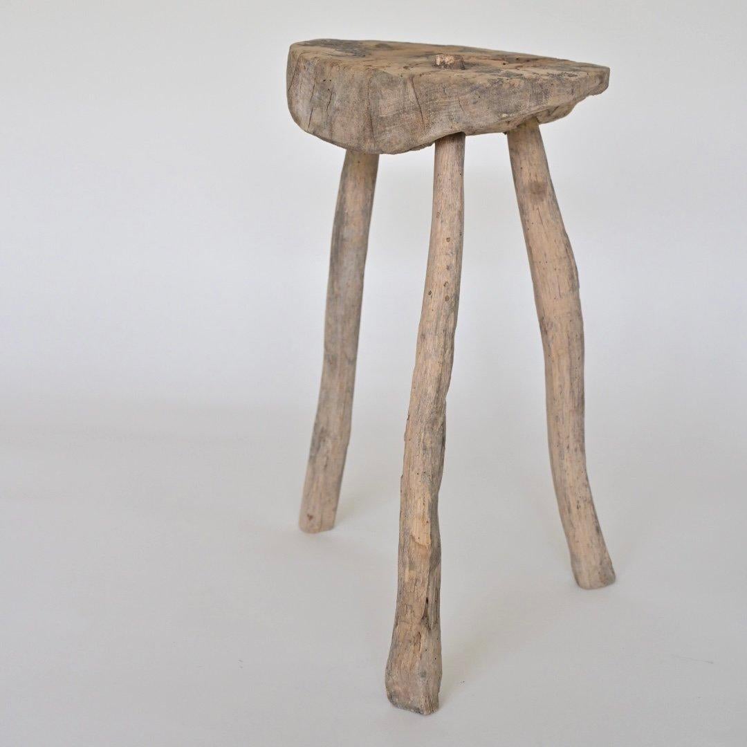 Rustic brutalist wooden tripod side table / stool. Designer and year unknown.