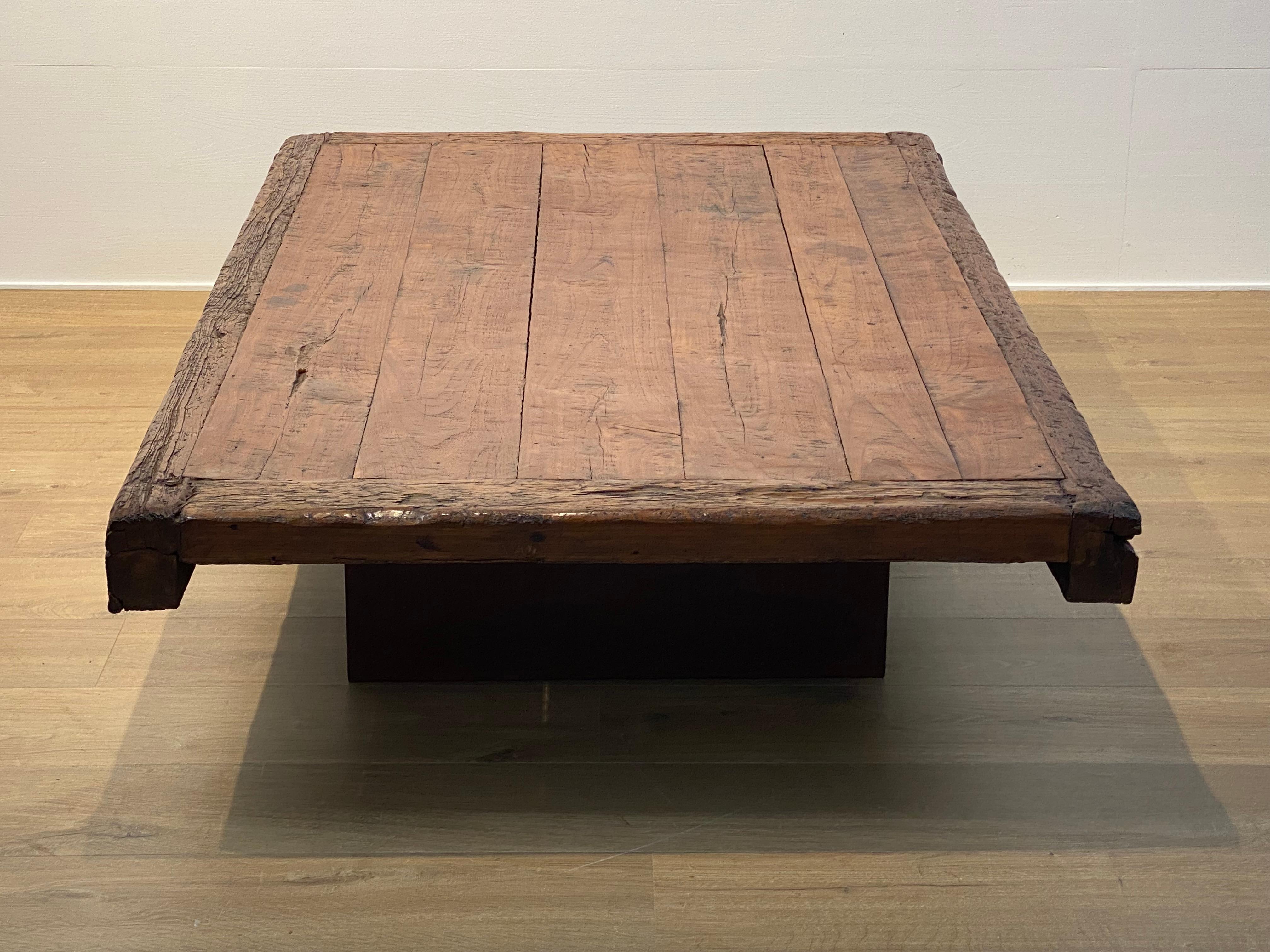 An antique,brutalist Sofa Table made out of an ancient children's bed,
Indonesia from around the 1960 ies, mounted on a contemporary wooden base, 2 rectangular wooden blocks,
good patina and shine of the wood, very decorative table,
good condition