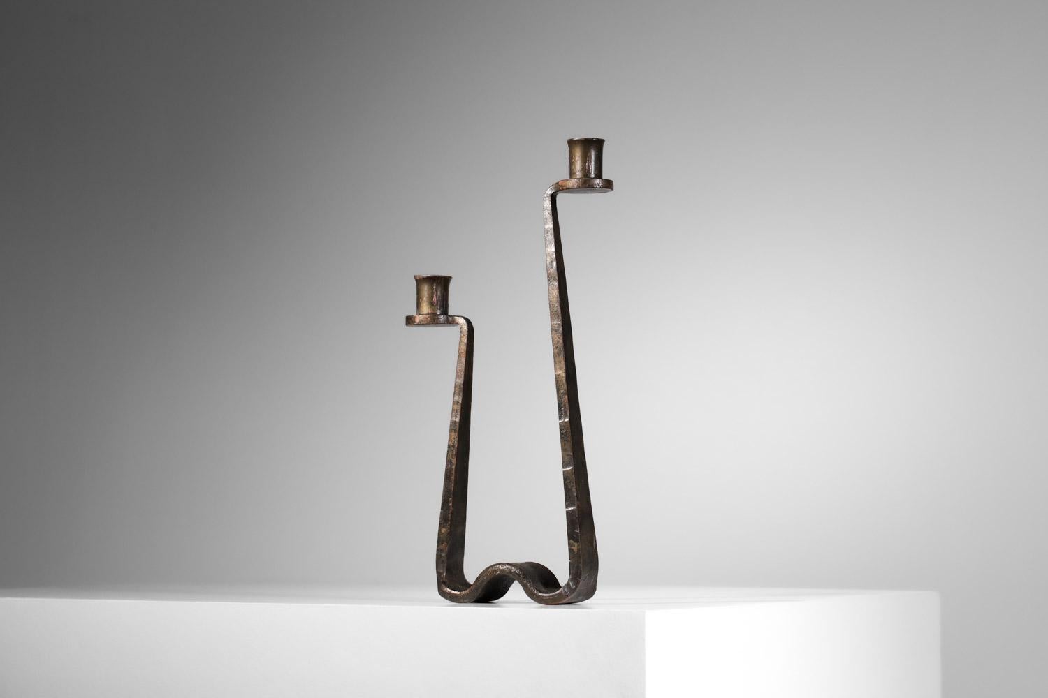 Brutalist wrought-iron candlestick from the 1950s in the taste of Ateliers de Marolle.  Sleek, designer shape holds two candles. Beautiful vintage condition, with traces of age and use. Nice patina of age on the metal.