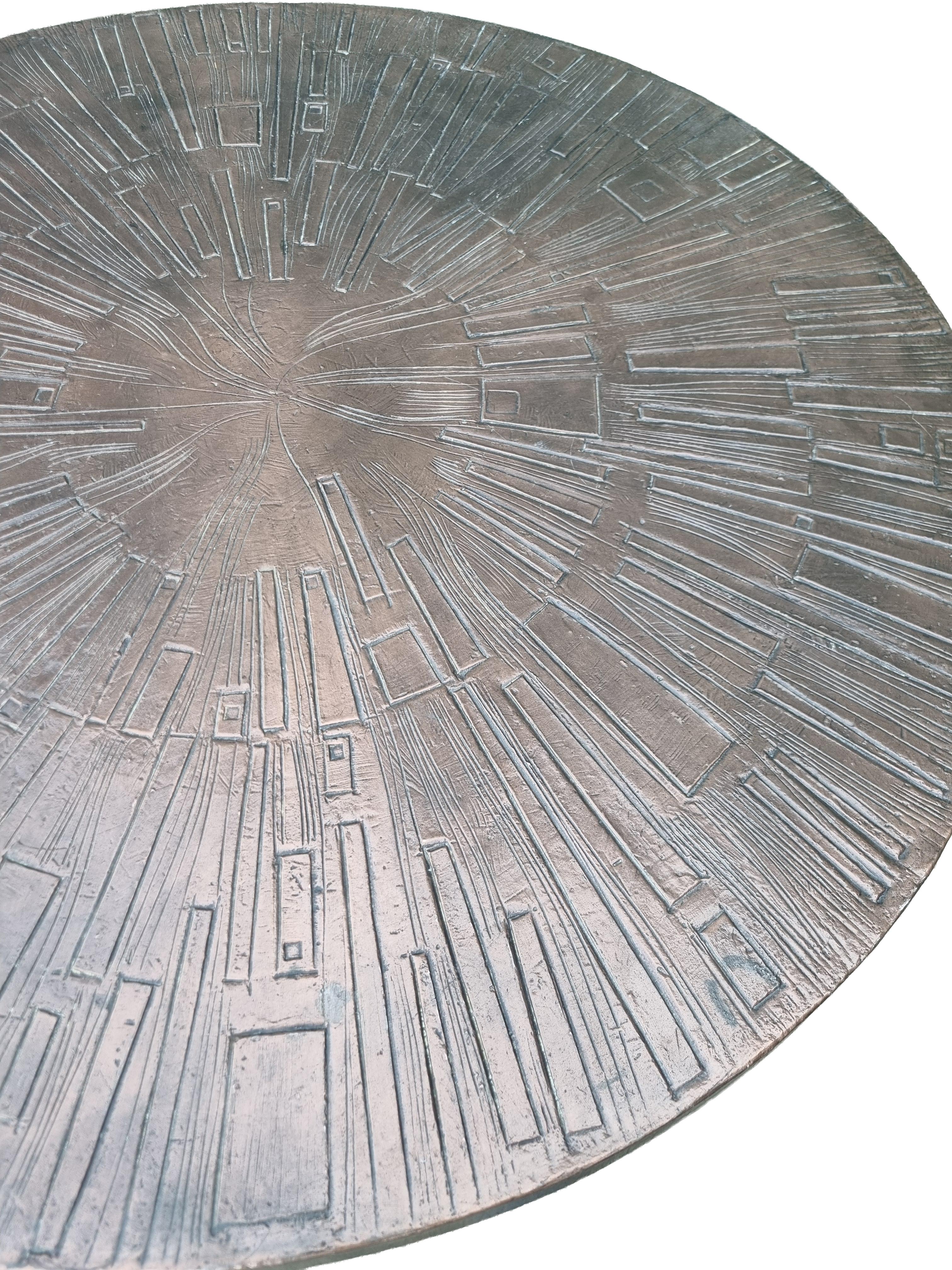 Striking round coffee table in a bold Brutalist / Spanish Revival style, made in Europe around the 1970s. The sculptural base is executed in hand-forged, blackened iron, formed by six broad, curved legs that flare gracefully to the floor and are