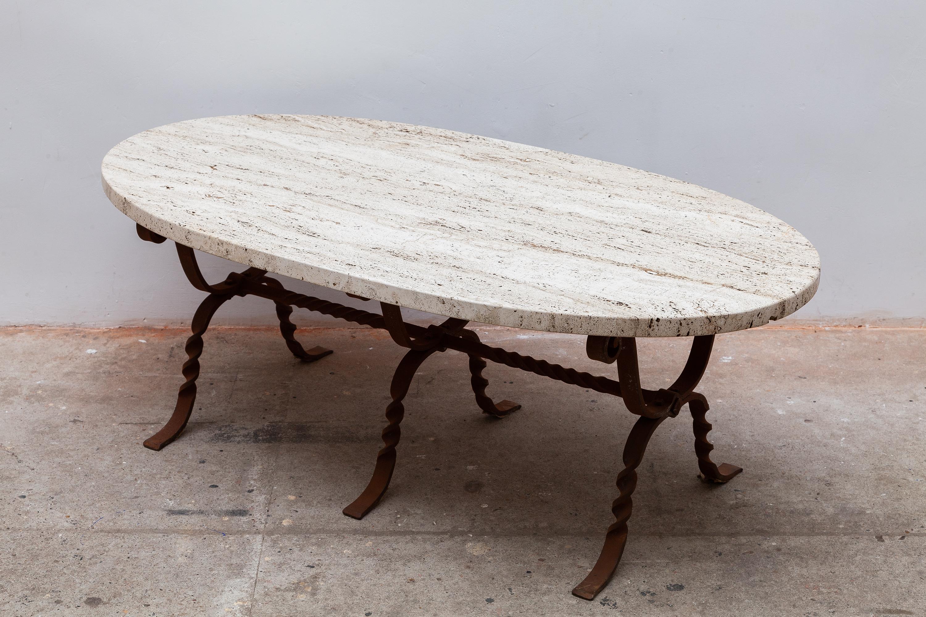 Brutalist decorative wrought iron base with a beautiful travertine top in the natural tone of white and brown. The turned metal is a warm brown tone. Original condition. Measures: Width of 130 cm.