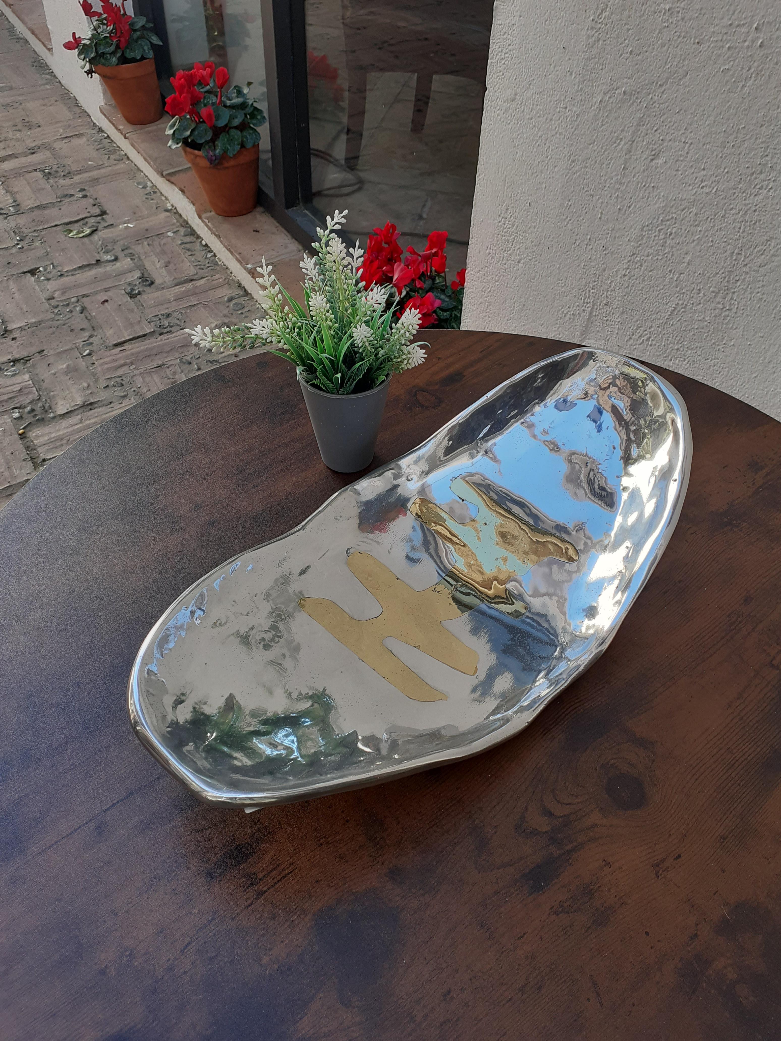 The Bowl was created by David Marshall, from sand cast aluminium and brass.
 We use recycled materials all our pieces are handmade, mounted and finished in our foundry and workshop in Spain.
It is certified authentic by the Artist David Marshall
