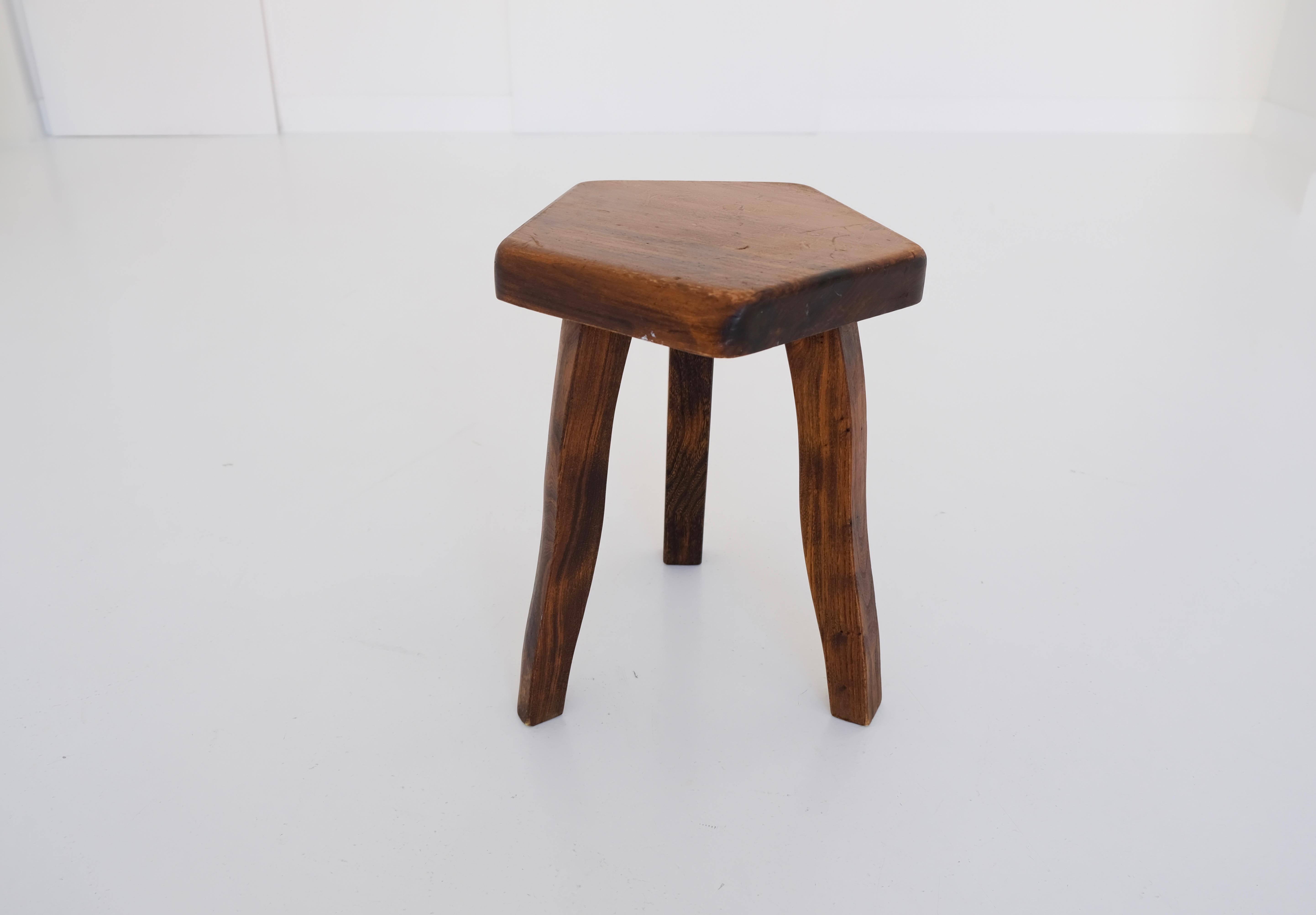 The solid stool or tripod is made of stained elm wood and sculpturally crafted by hand. Rustic, minimalistic, brutalistic – bringing a sense of organic power to every understated design interior.