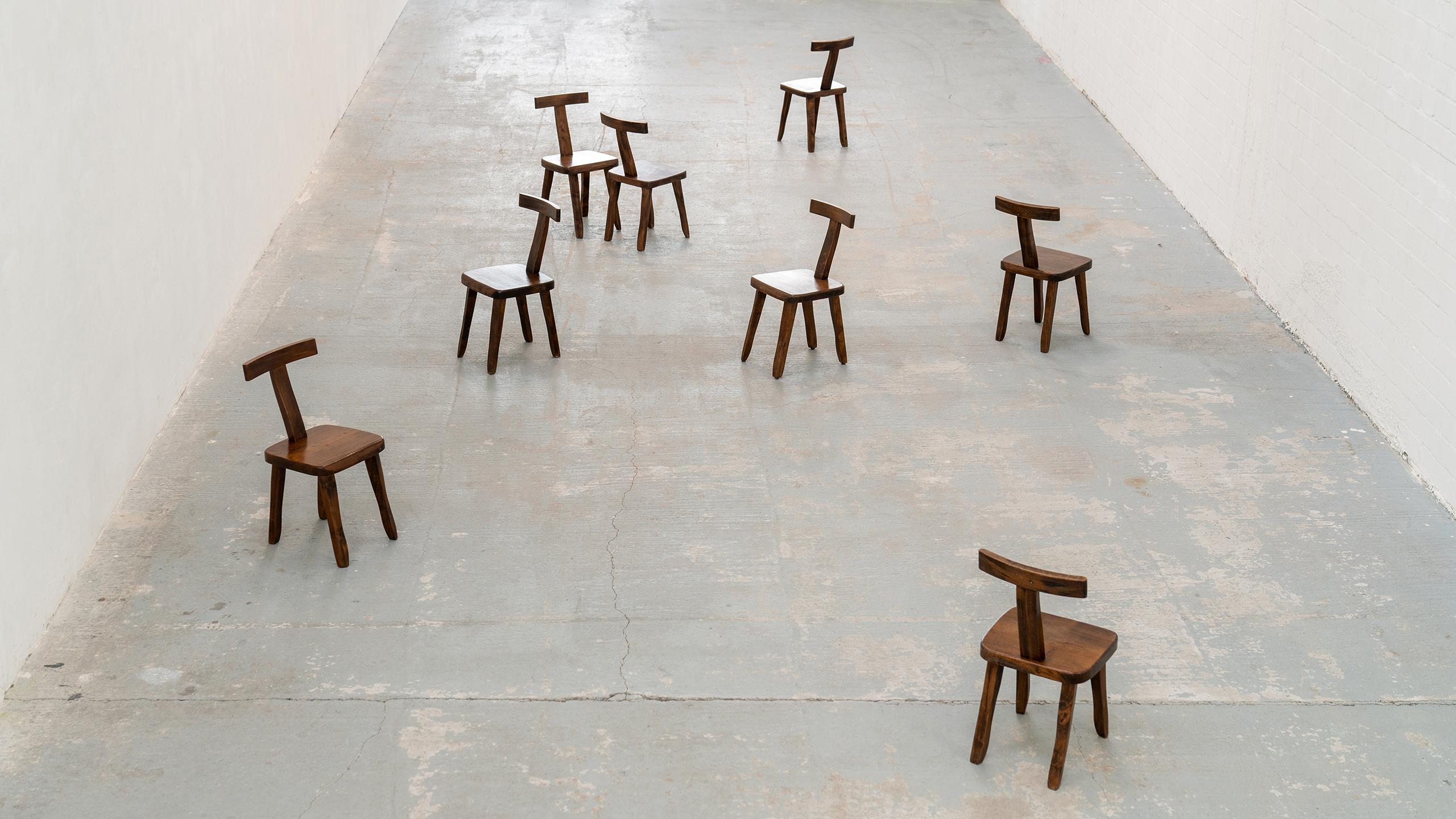 Brutalistic & Minimalistic - Olavi Hänninen - T chairs in solid elm - 1958 for Mikko Nupponen, Finland 
Set of 8 (we can provide 10 chairs if needed)

These solid chairs are made of stained elm wood and sculpturally crafted by hand. 
Rustic,