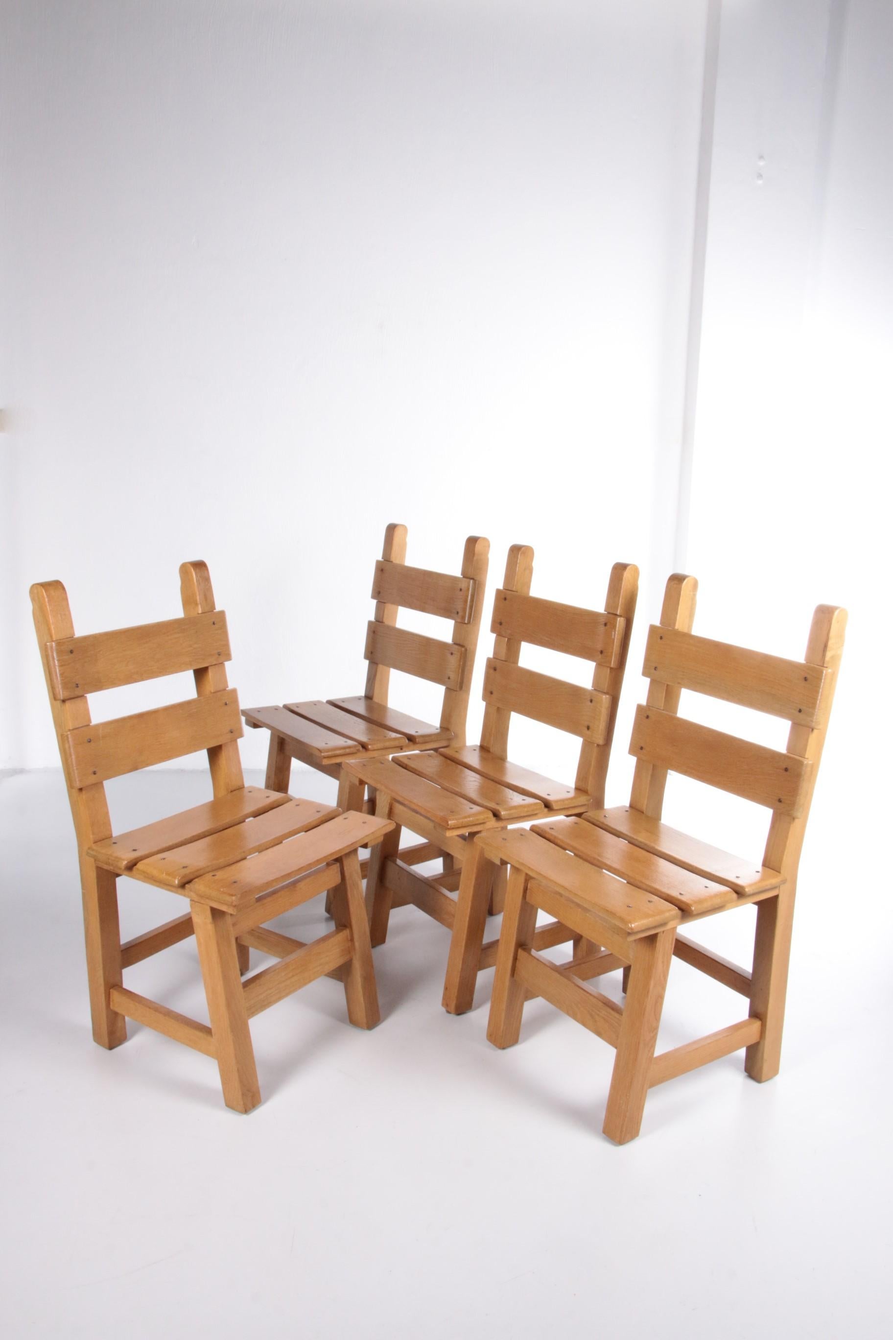 Brutalistic set of 4 sturdy wooden chairs 1980

Organically shaped set of four Spanish dining room chairs from the sixties.
The chairs are made of solid oak.
Both the seat and the backrest are made of solid light, straight oak.
Because the chairs