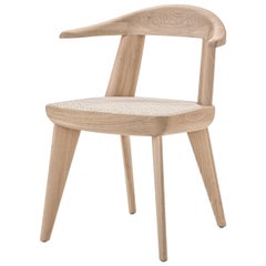 Fauteuil brutal en bois massif avec assise en rotin conçu par Craig Bassam