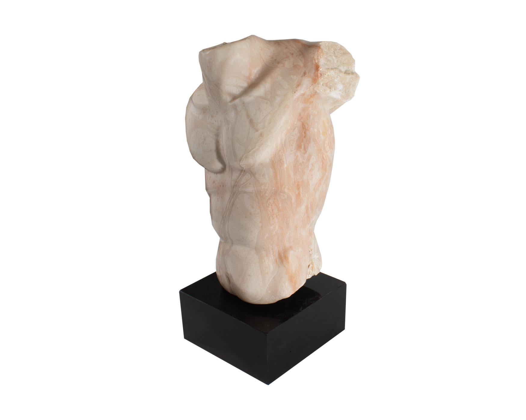 A stone sculpture of a torso by American artist Bryan Ross. The piece is constructed from pink alabaster stone and rests on a black base. The idealized male torso naturally showcases the alabaster's marbling which mimics veins and tendons. The