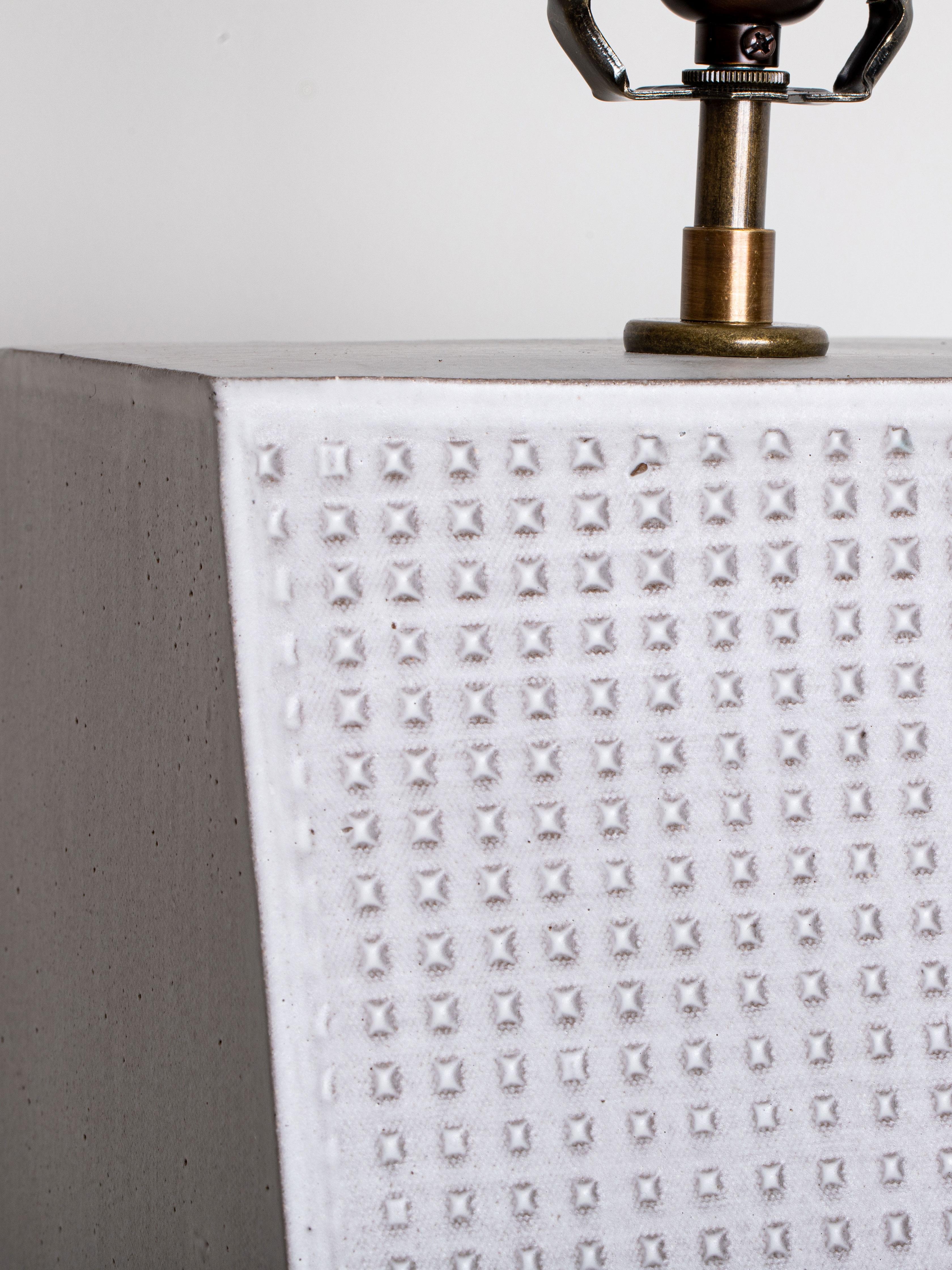 Our stoneware Grace Lamp is
handcrafted using slab-construction
techniques. The lamp’s pattern is created by rolling the surface with textured rolling pins and rods.

FINISH

- Dipped glaze, pictured in chalk 
- Antique brass fittings
-