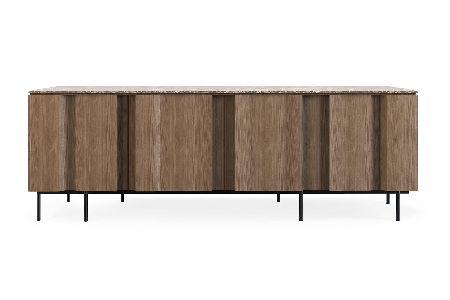 Bryant sideboard by Collector
Materials: Marble top. Oak wooden doors and structure. Legs in metal with a painted finish. Lacquered interior.
Dimensions: W 202 x D 50 x H 72 cm 
Also available in walnut.

A series of vertical lines runs from top to