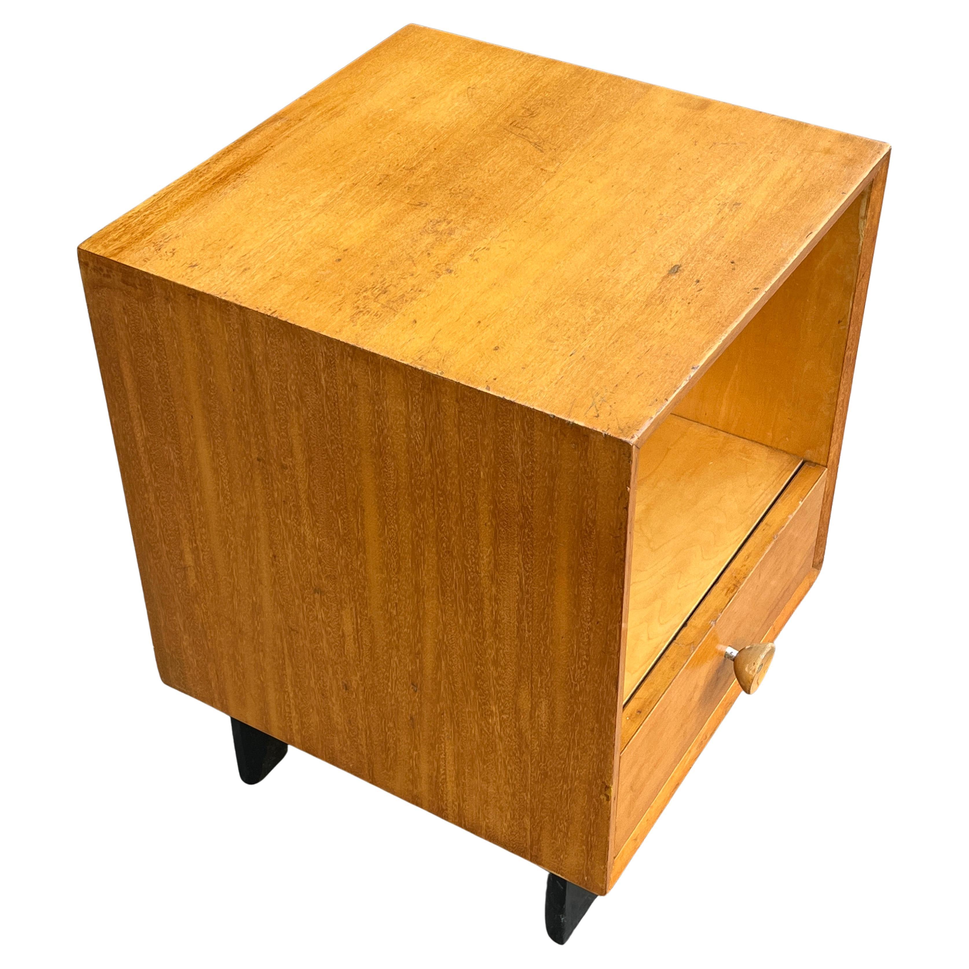 George Nelson designed nightstand, as part of Herman Miller’s modular basic storage components. A one drawer Primavera wood side cabinet with open storage. Original foil George Nelson-Herman Miller identifying label inside drawer. Original cupcake