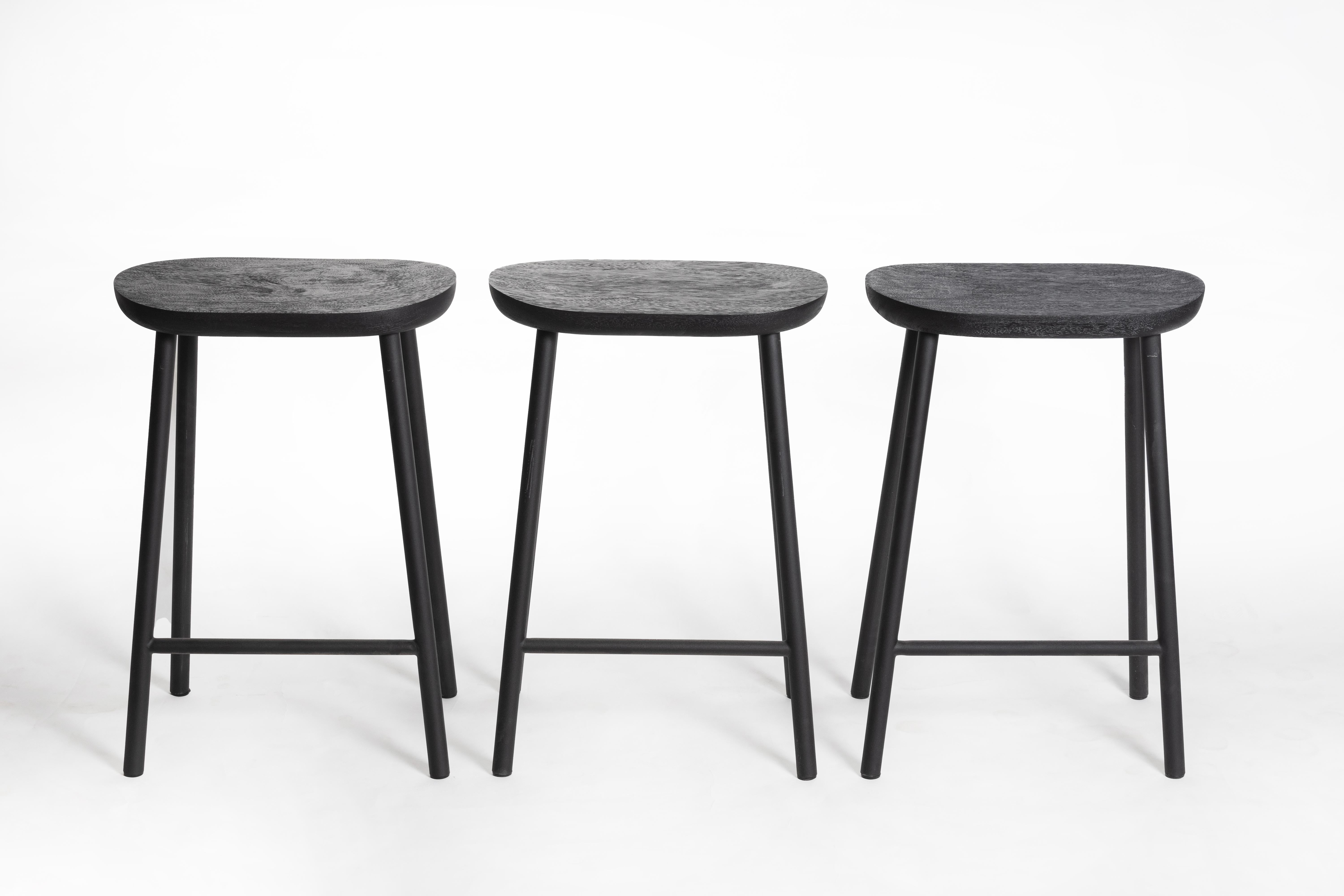 Thai Buacheen, Rough Black Monkey Pod Wood Bar Stool with Black Powder Iron Legs For Sale
