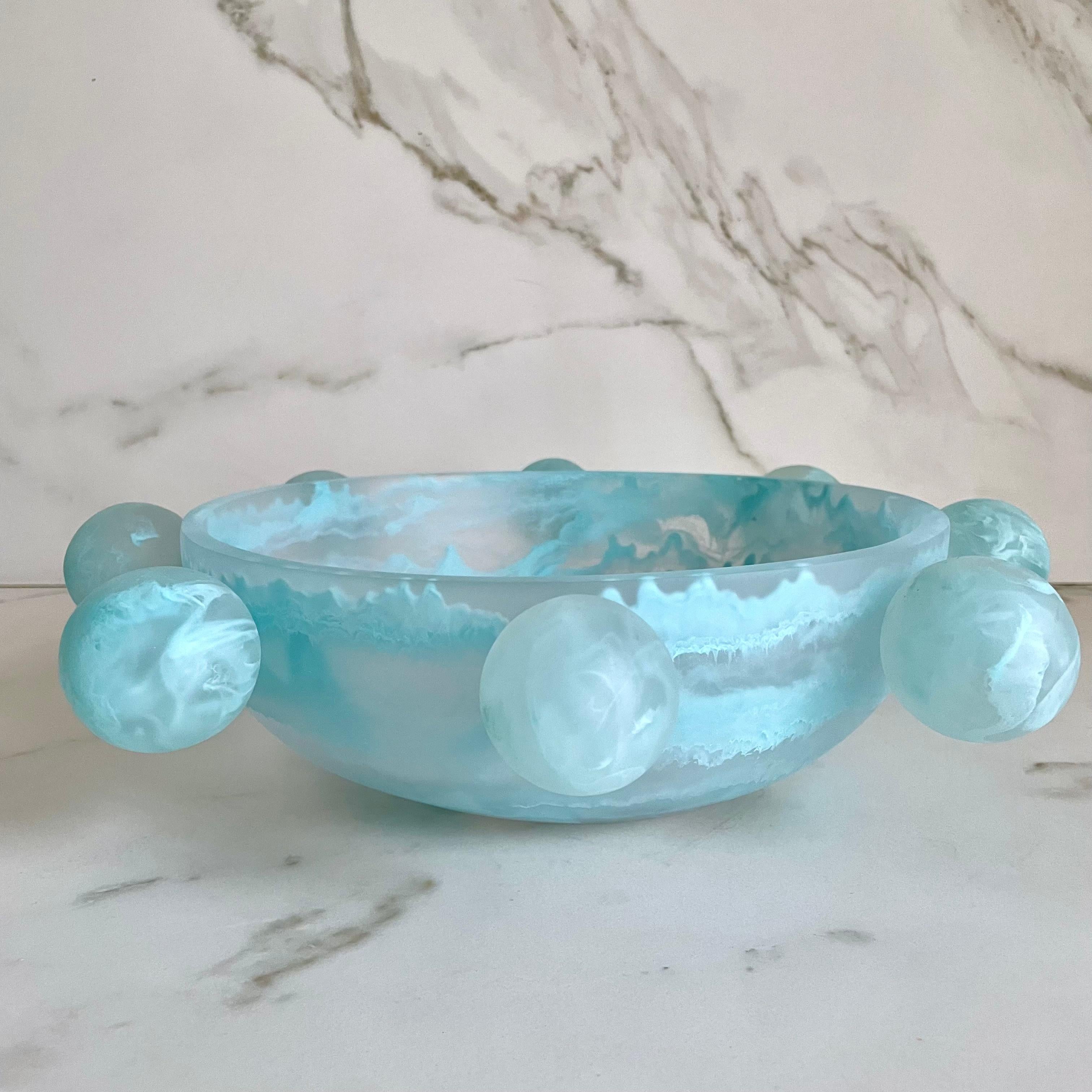 Our Bubble Bowl is handmade in clear resin with aqua marbled texture. Its modern, fun and unique design makes it a statement piece and can be used as decor or as a fruit platter.

Designed by Paola Valle and manufactured in Mexico City by