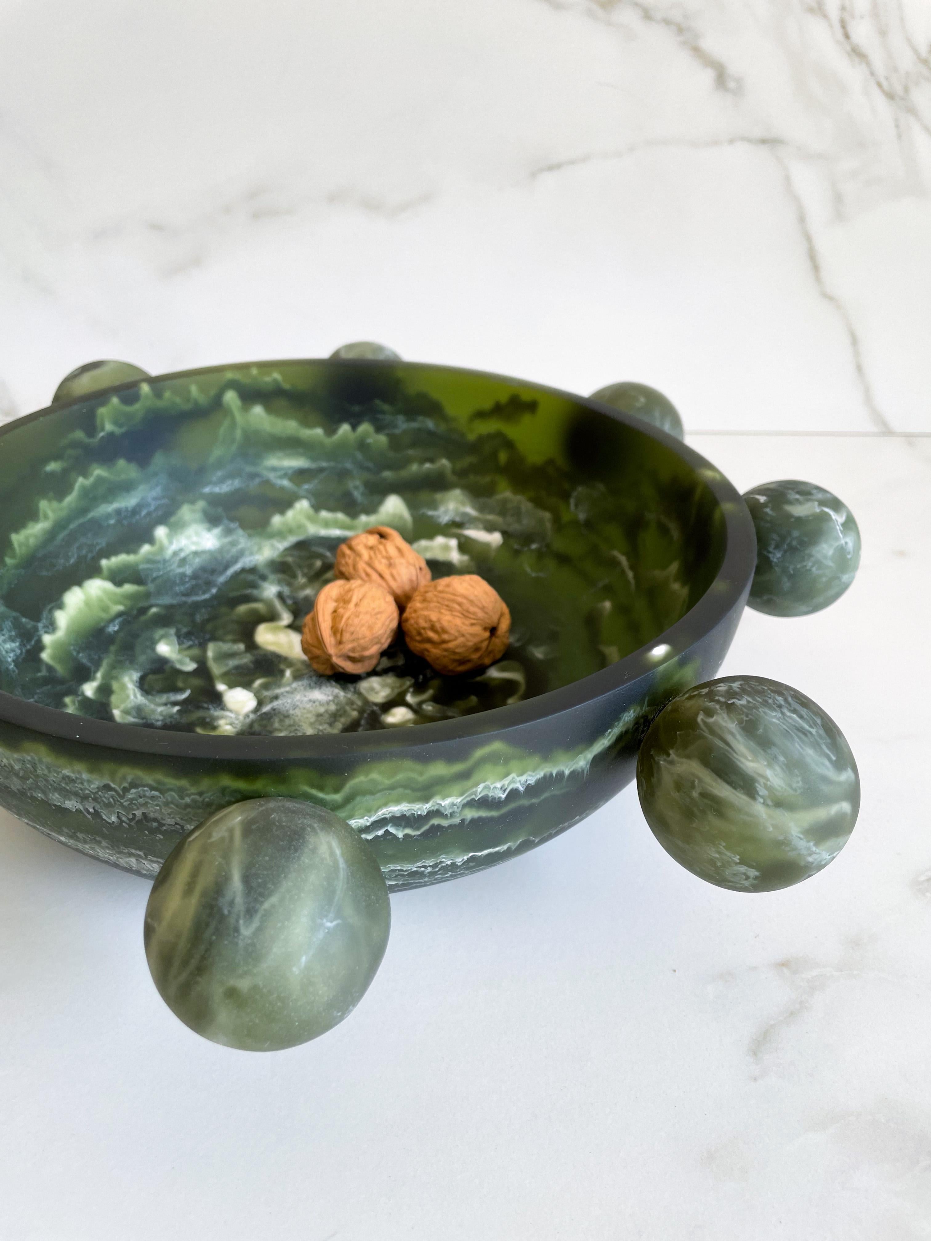 Our Bubble Bowl is handmade in dark green & white marbled resin. Its modern, fun and unique design makes it a statement piece and can be used as decor or as a fruit platter.

Designed by Paola Valle and manufactured in Mexico City by extraordinary