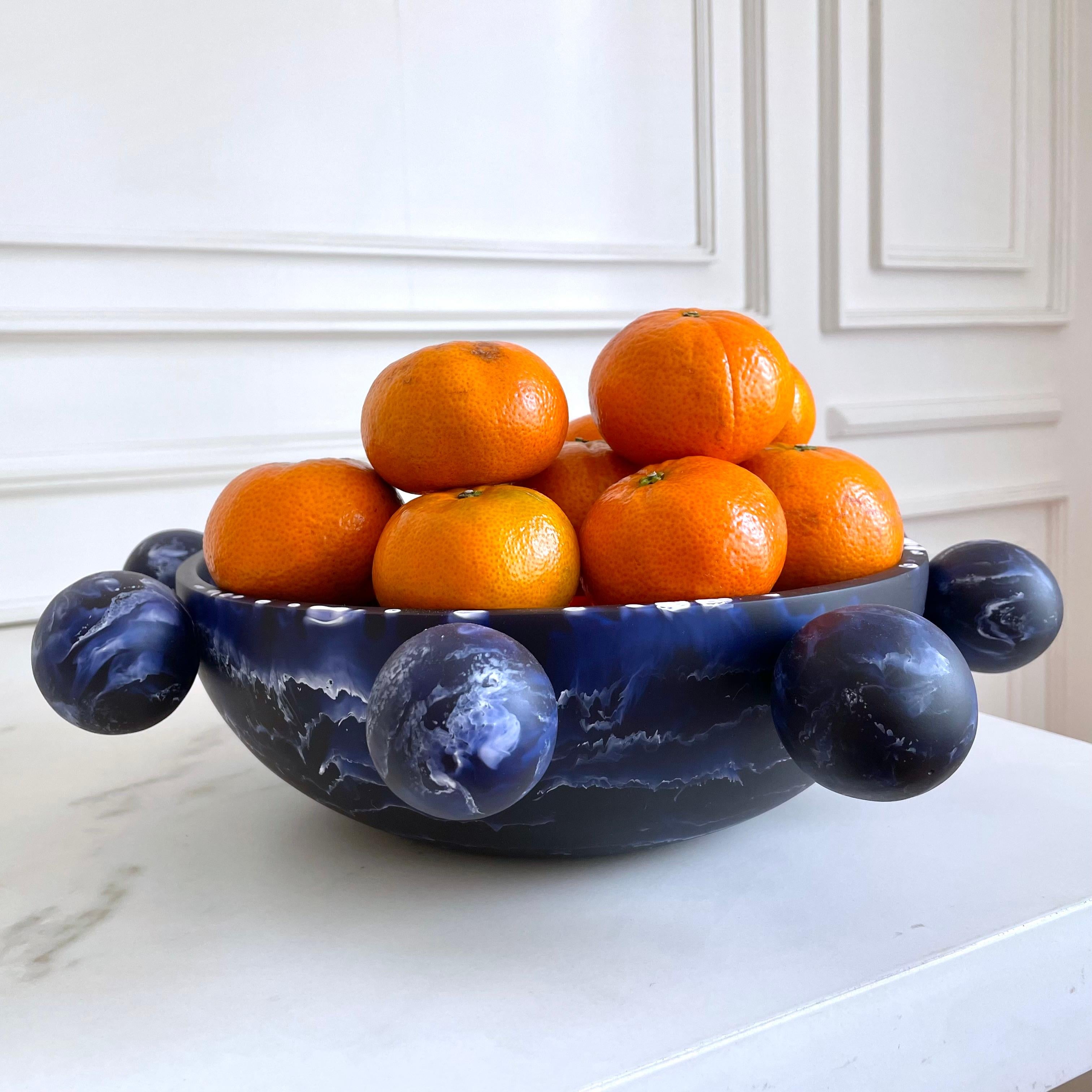 Our Bubble Bowl is handmade in navy blue & white marbled resin. Its modern, fun and unique design makes it a statement piece and can be used as decor or as a fruit platter.

Designed by Paola Valle and manufactured in Mexico City by extraordinary