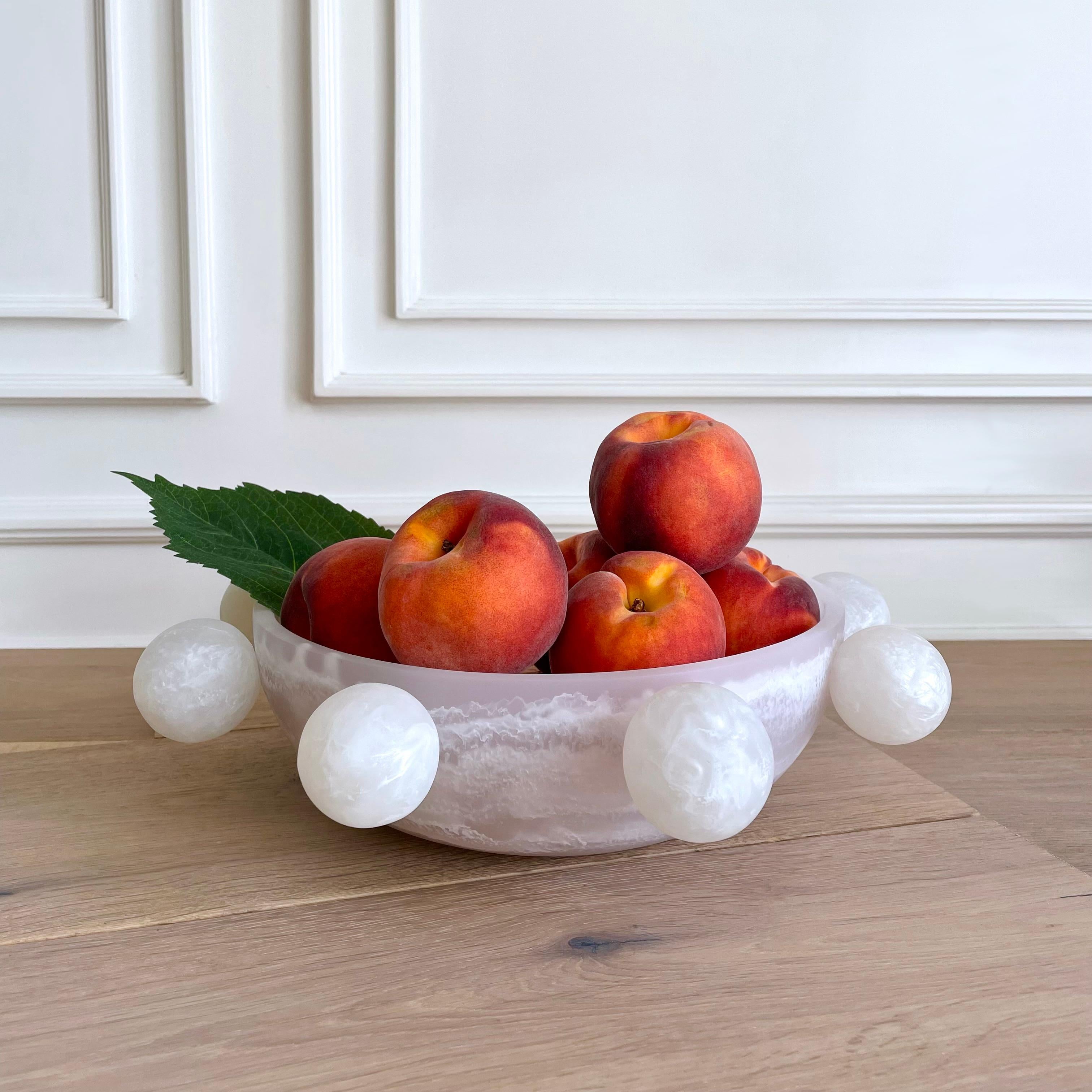 Our Bubble Bowl is handmade in white & pearl marbled resin. Its modern, fun and unique design makes it a statement piece and can be used as decor or as a fruit platter. 

Designed by Paola Valle and manufactured in Mexico City by extraordinary