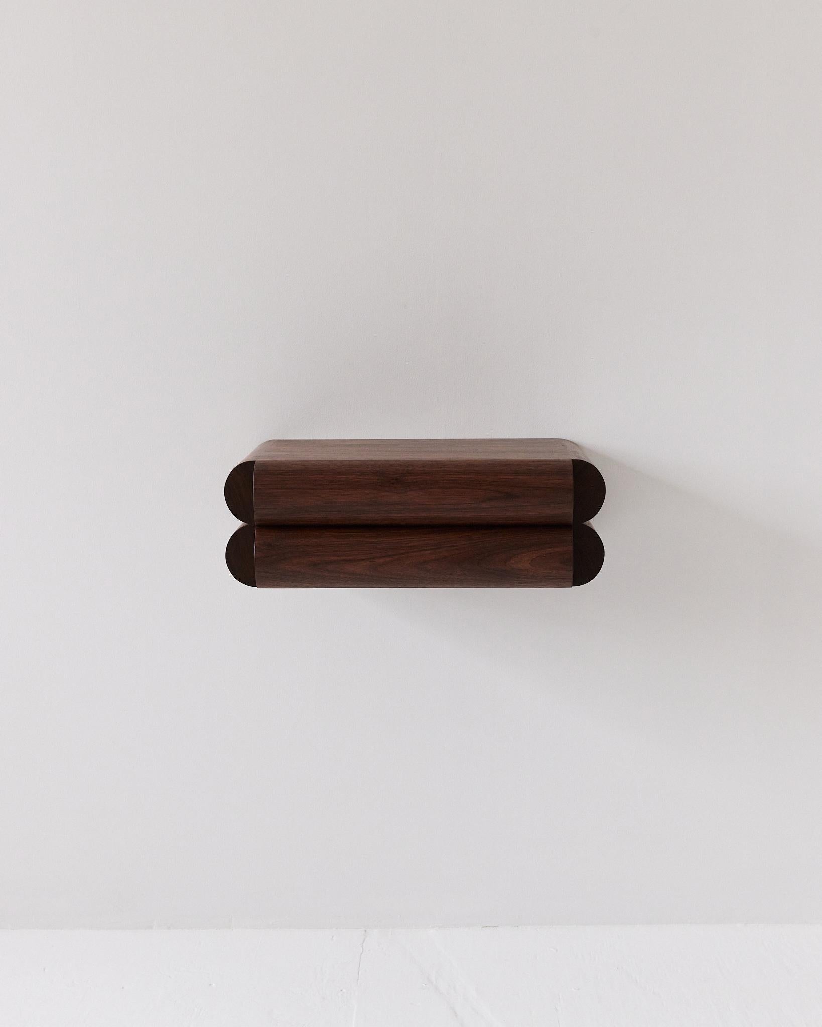 This small shelf with integrated drawer works perfectly as an entryway console or nightstand. The recessed handle pull keeps the design looking clean and sophisticated while camouflaging its function under a distinct and bold aesthetic.
