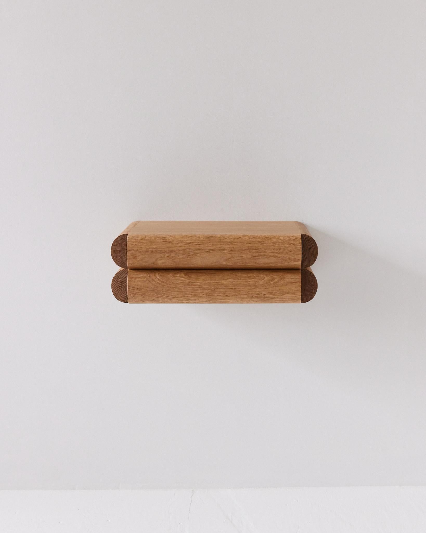 This small shelf with integrated drawer works perfectly as an entryway console or nightstand. The recessed handle pull keeps the design looking clean and sophisticated while camouflaging its function under a distinct and bold aesthetic.