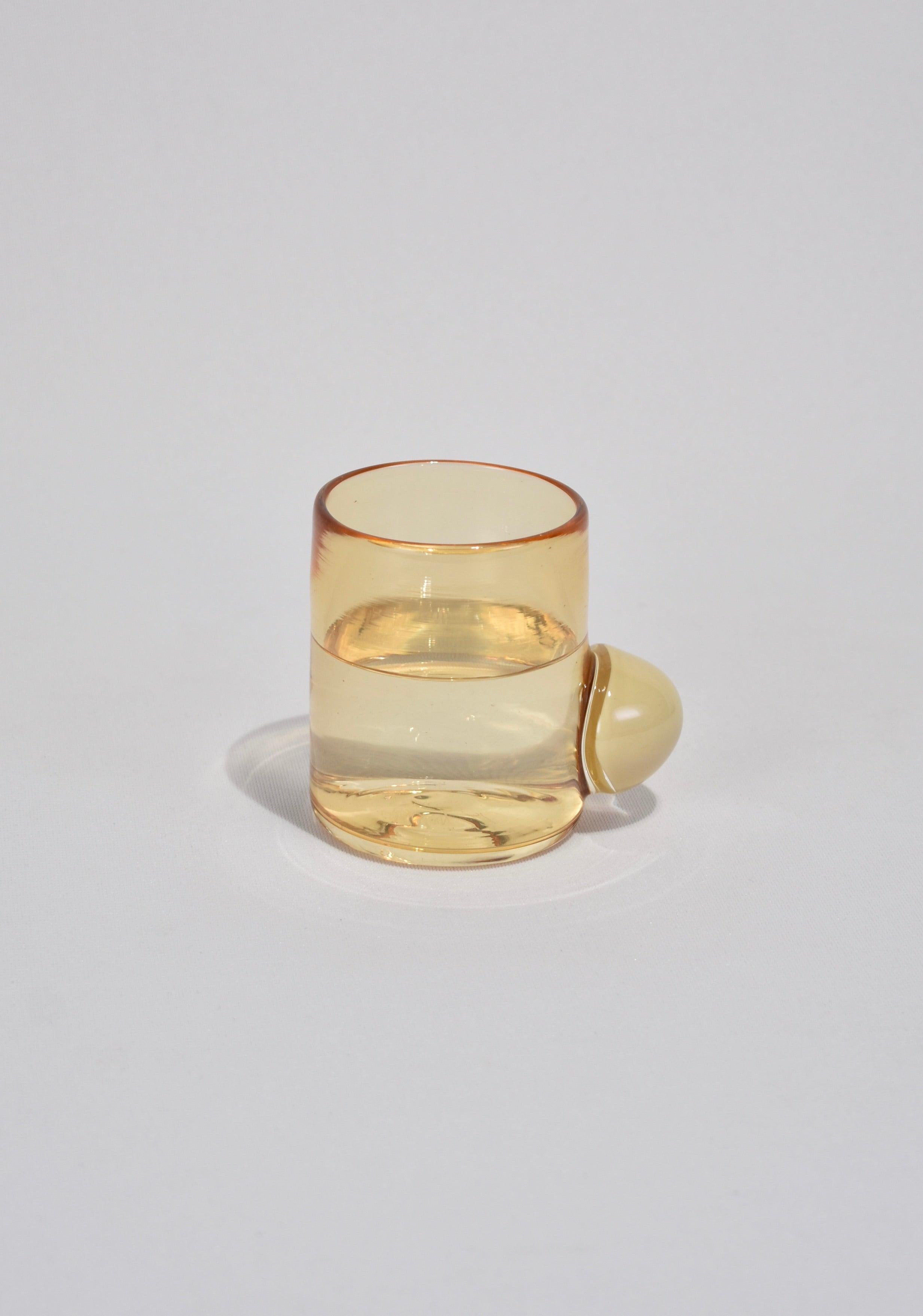 Blown glass tumbler in whiskey with a cream bubble handle. Perfect size for water, wine, juice, or spirits. Handmade in USA by Grace Whiteside of Sticky Glass.

Please note: Due to the handmade nature of this cup, subtle variations in form and