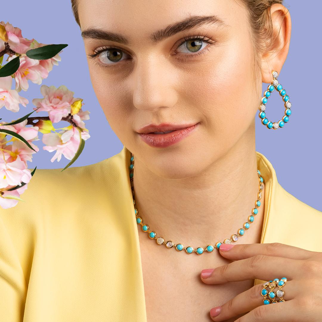 Our Bubble Diamond and Turquoise Necklace features an assortment of vibrant turquoise set within a thin bezel frame and illuminated by stations of sparkling petite white diamond clusters and moonstone stations positioned randomly along the strand.