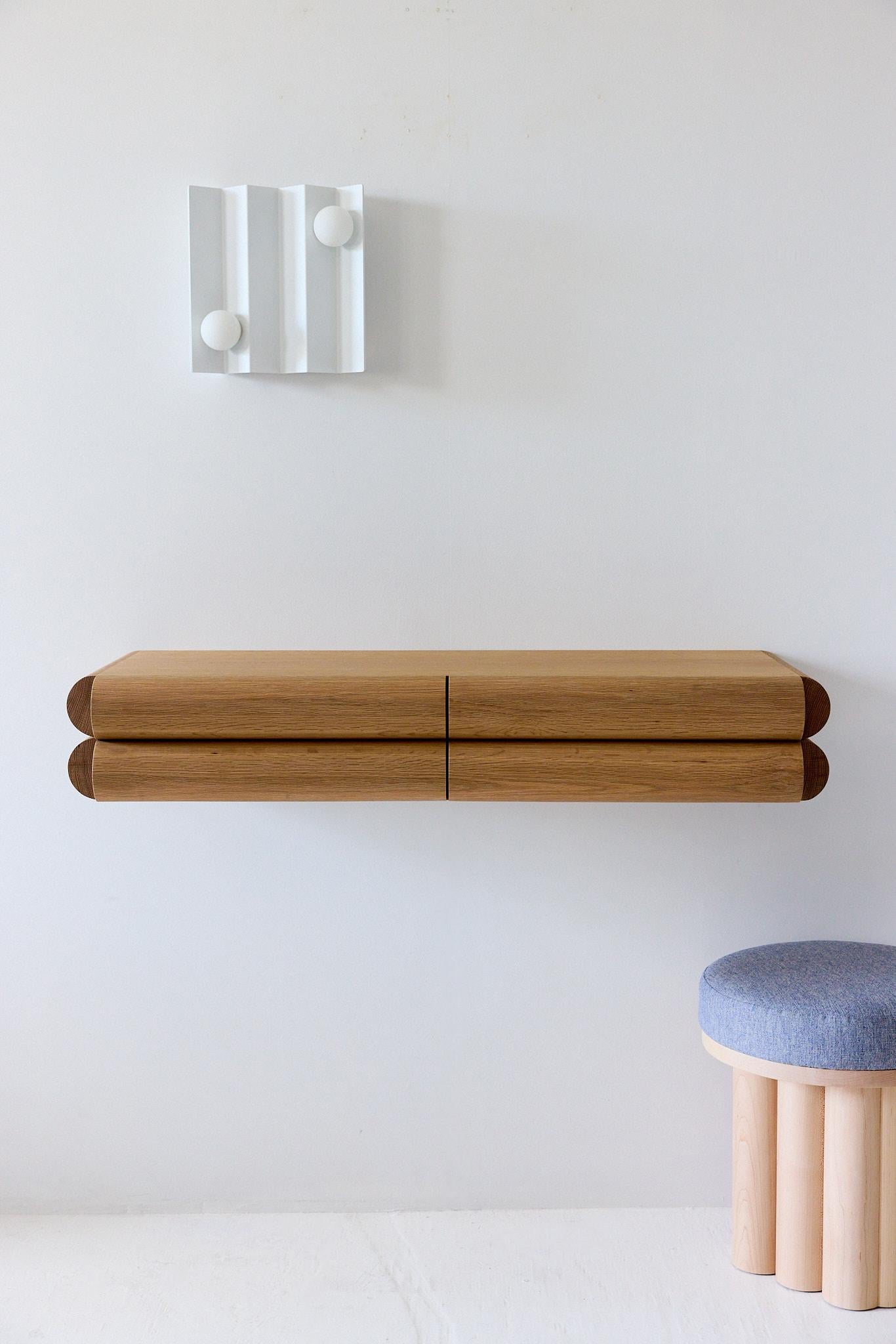 This small shelf with integrated drawer works perfectly as an entryway console or nightstand. The recessed handle pull keeps the design looking clean and sophisticated while camouflaging its function under a distinct and bold aesthetic.