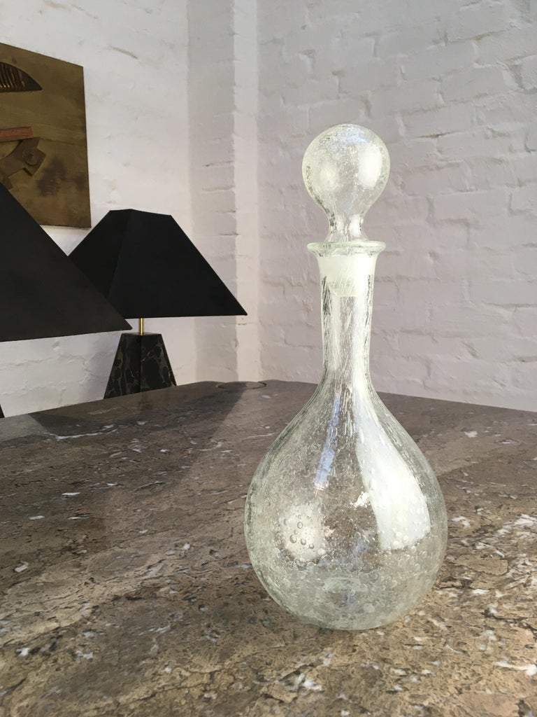Australian-Portuguese glass artist Julio Santos was an expert in his craft. This decanter is a lovely example of his work. Signed 'J. Santos' to the base and in excellent condition.

Santos died just a few years ago, leaving a legacy of over 50