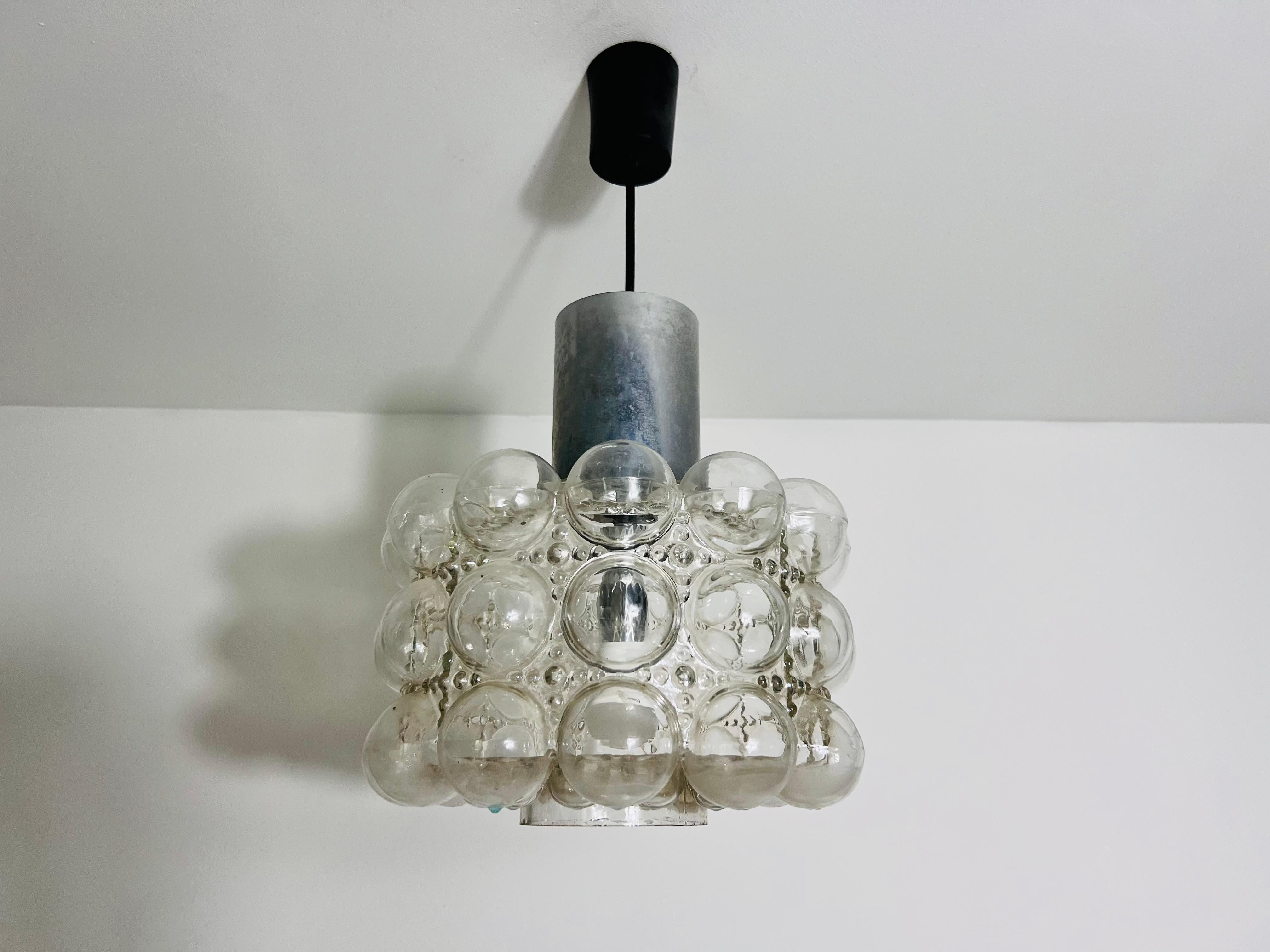 A bubble glass hanging lamp by Helena Tynell for Limburg made in Germany in the 1960s. Helena Tynell is a glass and ceramic designer who has worked for many European companies. One of her master works is this glass pendant lamp. It is fascinating