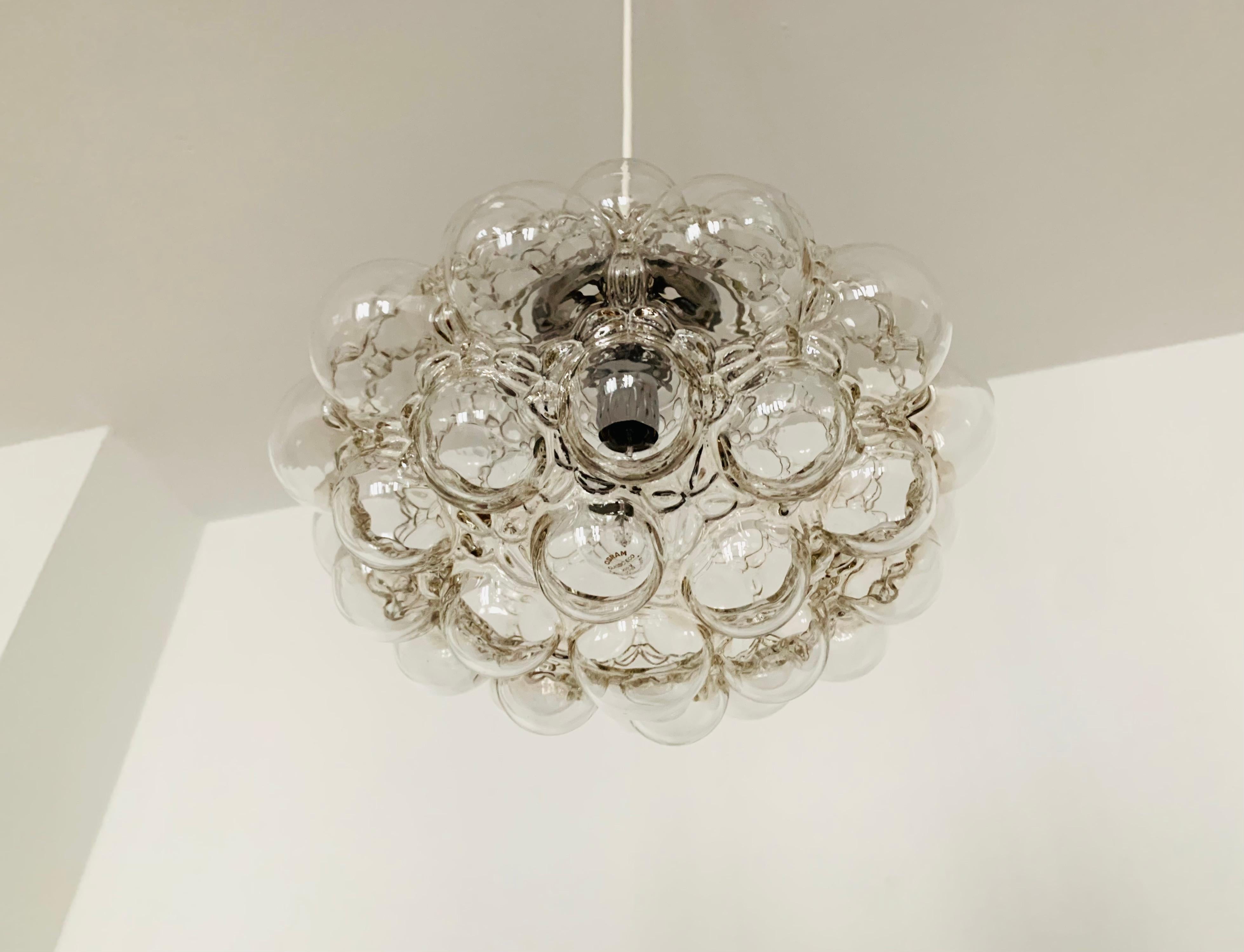 Very beautiful and very large bubble glass pendant lamp by Helena Tynell for the Limburg glassworks.
The lamp spreads a spectacular play of light in the room and enchants with its charisma.
Great high-quality workmanship and extraordinary
