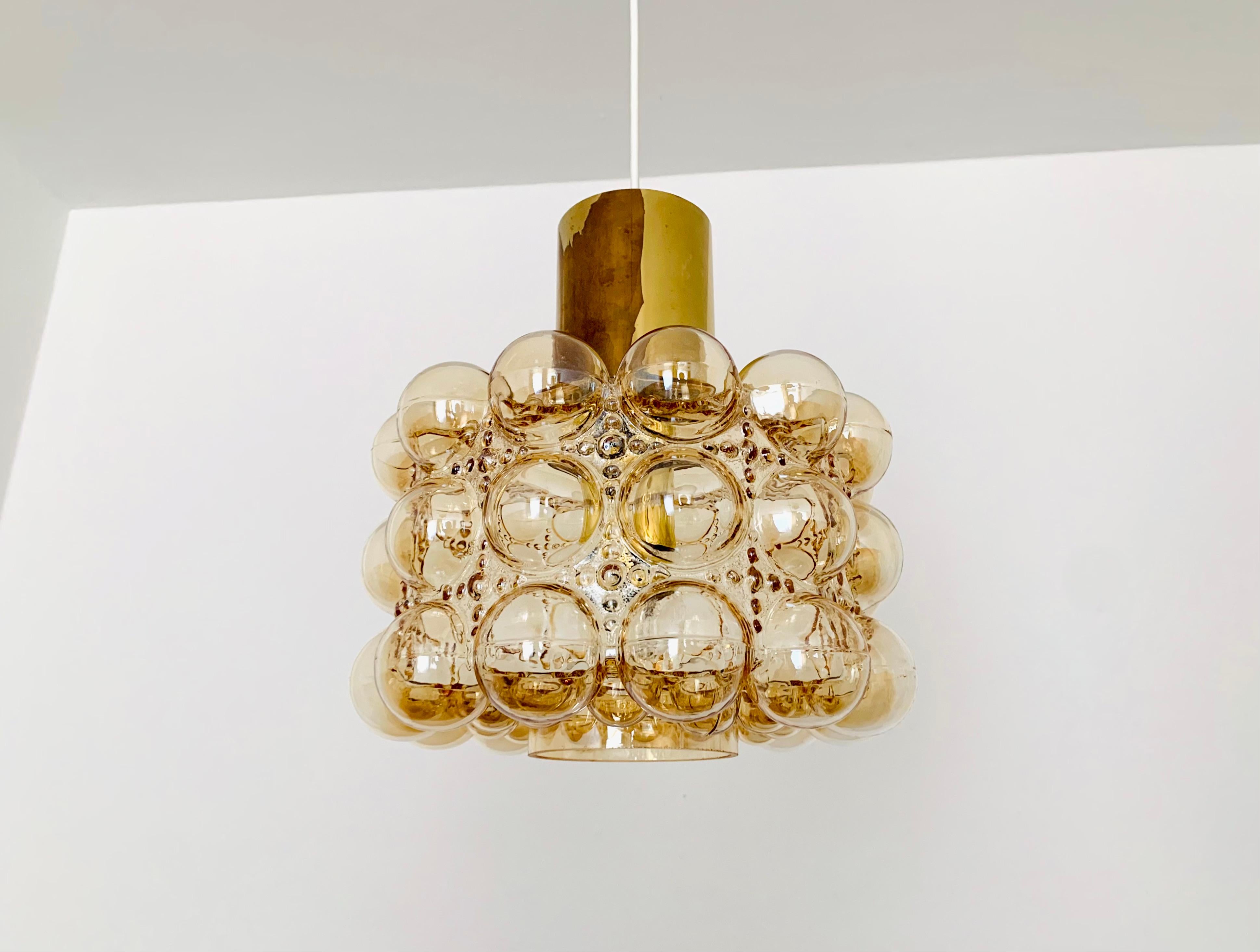 Very beautiful and large bubble glass pendant lamp by Helena Tynell for the Limburg glassworks.
The lamp spreads a spectacular play of light in the room and enchants with its charisma.
Great high-quality workmanship and extraordinary