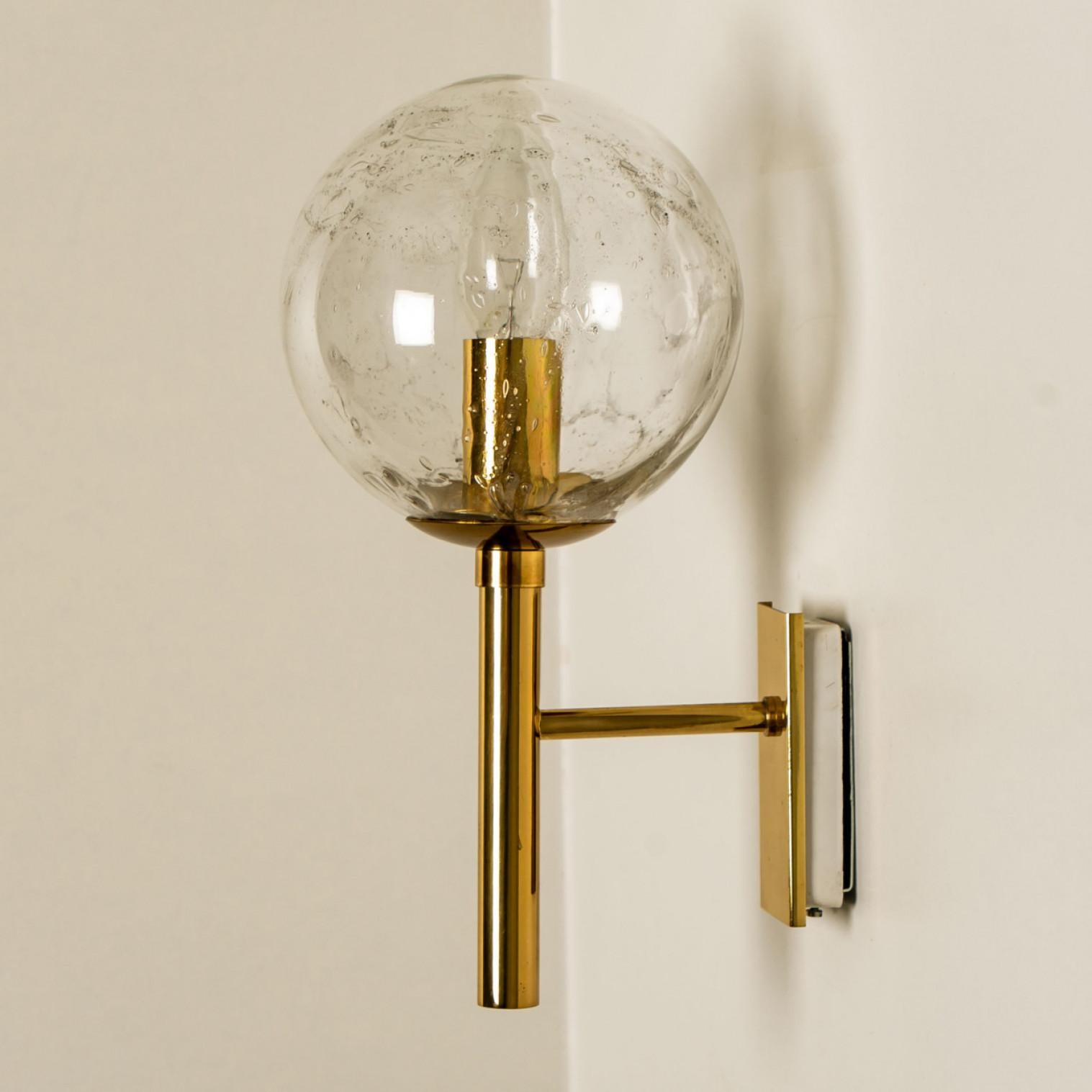 Wonderful high-end Doria wall lights. Manufactured in the 1960s in Germany, Europe by Doria Leuchten.
With a clear and blown glass bulb. The stylish elegance of this lamp suits many environments, from Mid century to Hollywood Regency, from Danish