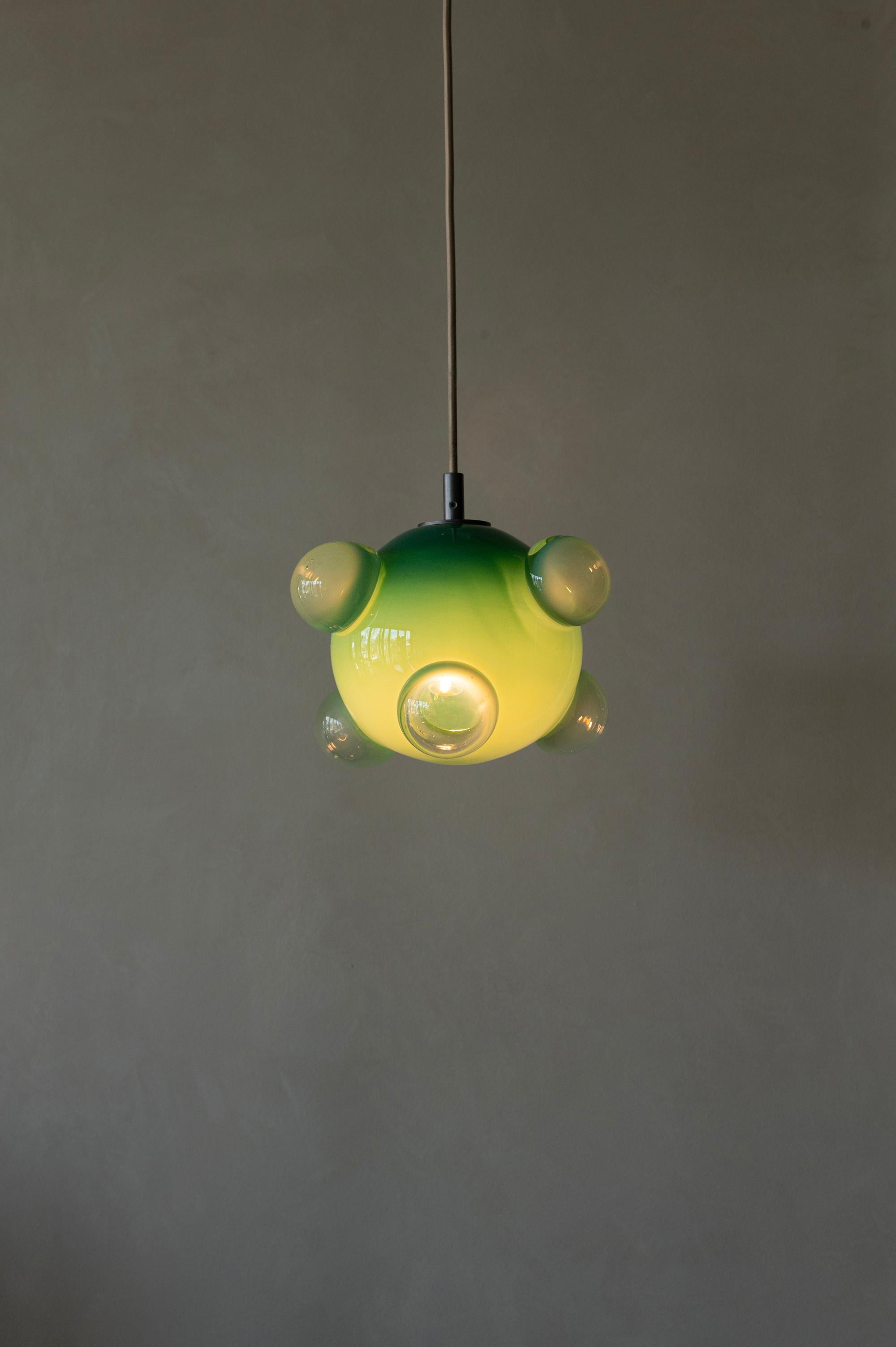 One of Sticky Glass's most classic styles, suspended from the ceiling! These bulbous pendants carry 6 exterior chambers that give a window into the heart of the pendant while also proving a unique optic dance. 

This form illuminates the fluid and