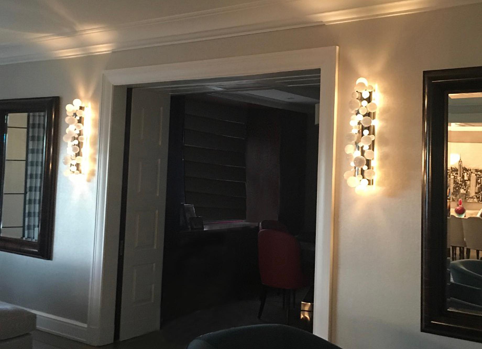 Pair of bubble rock crystal sconces with the polish nickel mounted. Created by Phoenix gallery NYC.
Each sconce installed four sockets. Use four 60w LED warm light bulbs. Total 240w max. Light bulbs included.
Recommend J-box size 2