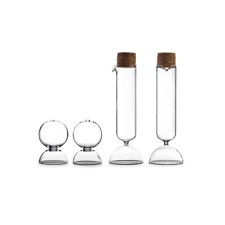 Bubble, designed by Gordon Guillaumier, is a salt and pepper Shaker set made in transparent blown glass. In the same family there is the oil and vinegar dispenser set available on 1stdibs as well.