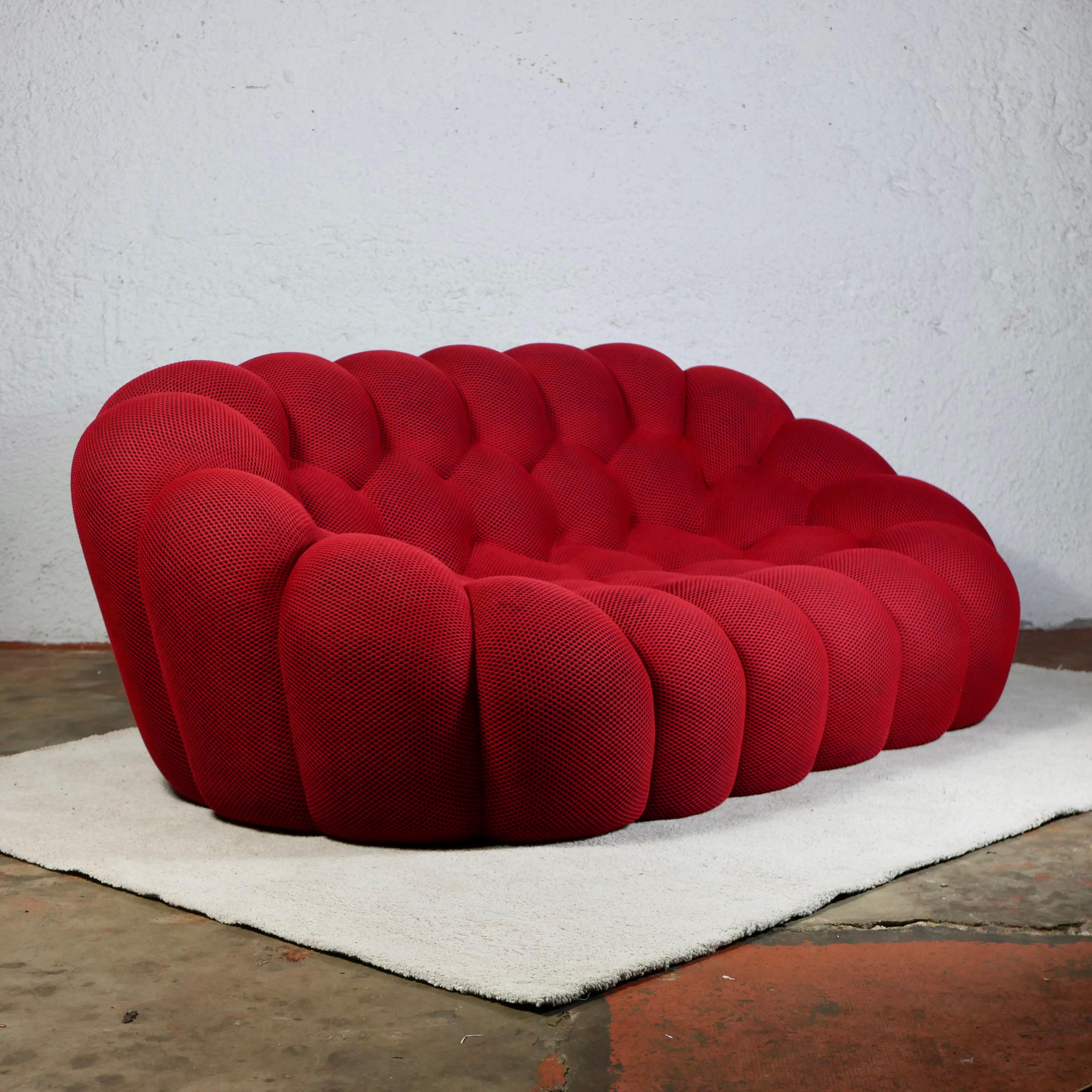 Stunning Bubble sofa, designed by Sacha Lakic in 2014 for Roche Bobois. Entirely handmade sofa in its original red Techno 3D fabric which perfectly follows the rounded and reassuring shapes of the sofa.
