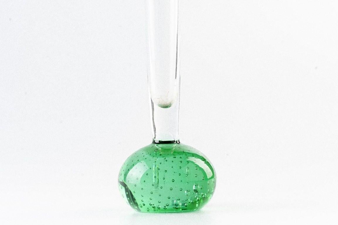 This Bubble Soliflore is a glass vase with a green base and a transparent neck.

Realized in Northern Europe during the 1970s.

Excellent condition.