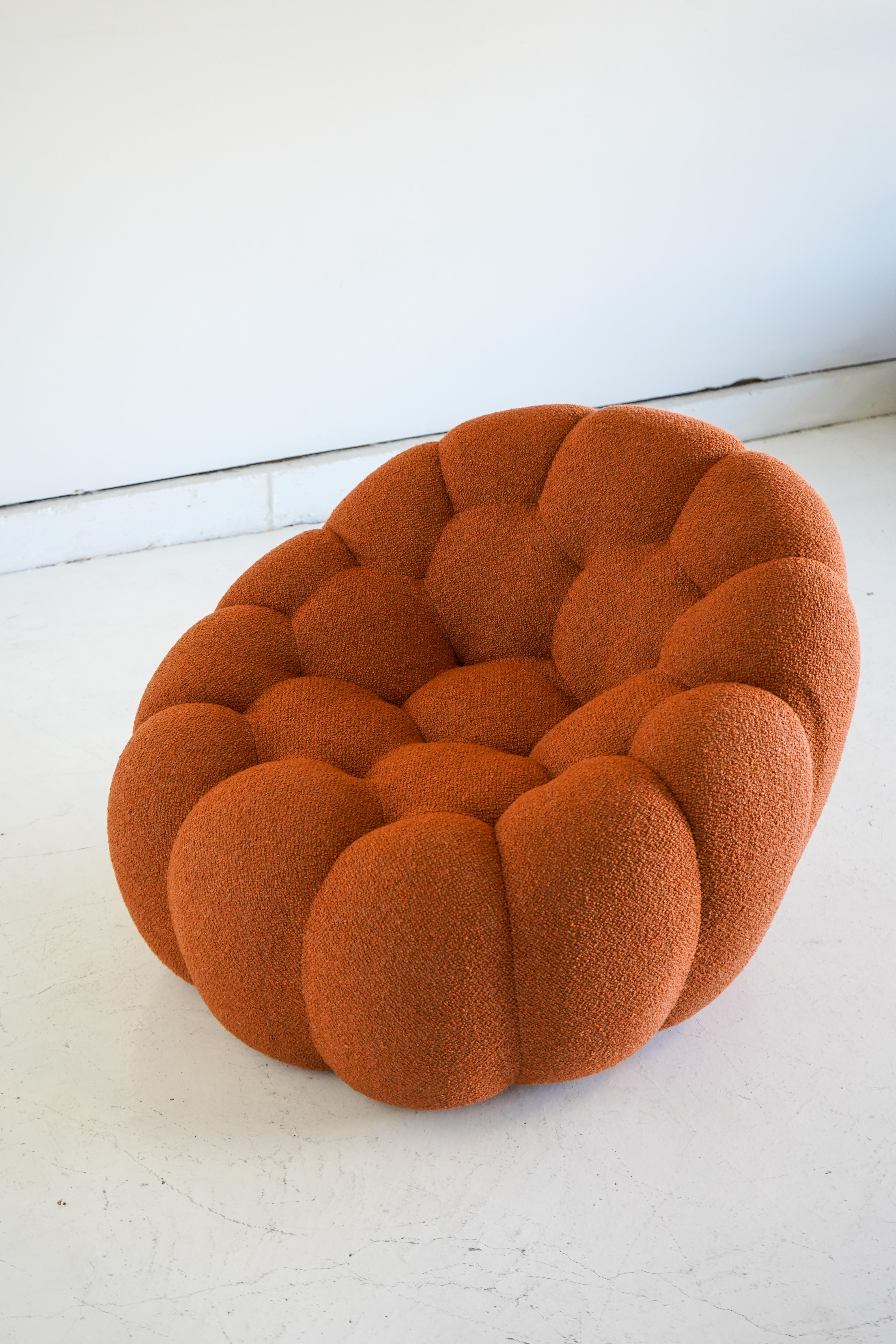 Designed in 2014 by Sacha Lakic for Roche Bobois, the Bubble series quickly became one of the iconic French manufacturer’s most beloved series. 

This example in orange boucle swivels gracefully with a smooth return mechanism and is in excellent