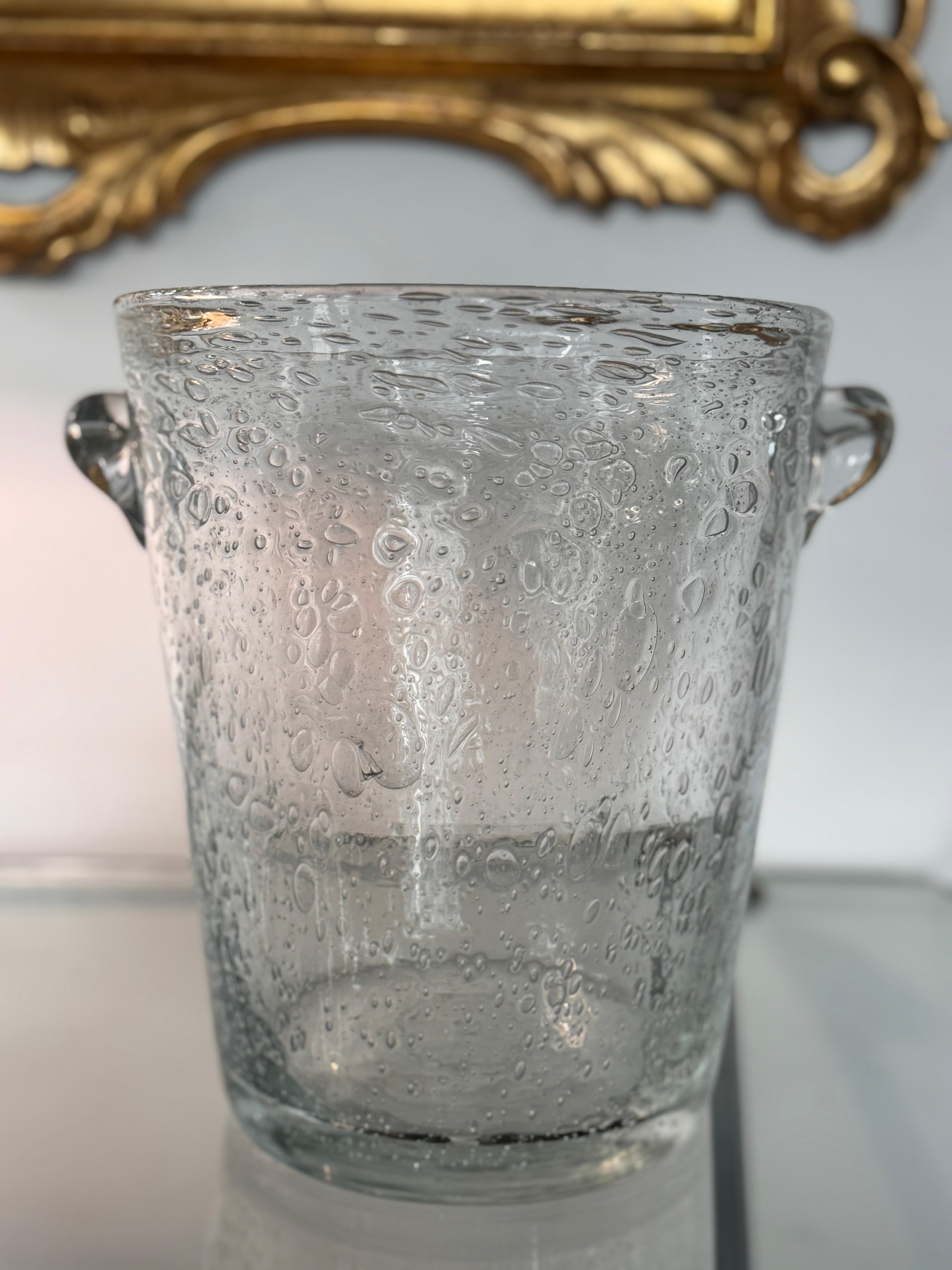 Hand-blown at La Verrerie de Biot on the Côte d’Azur, this classic French vintage 1960s champagne bucket shows the maison’s signature verre bullé thousands of suspended air bubbles created during blowing for a sparkling, watery effect. Excellent
