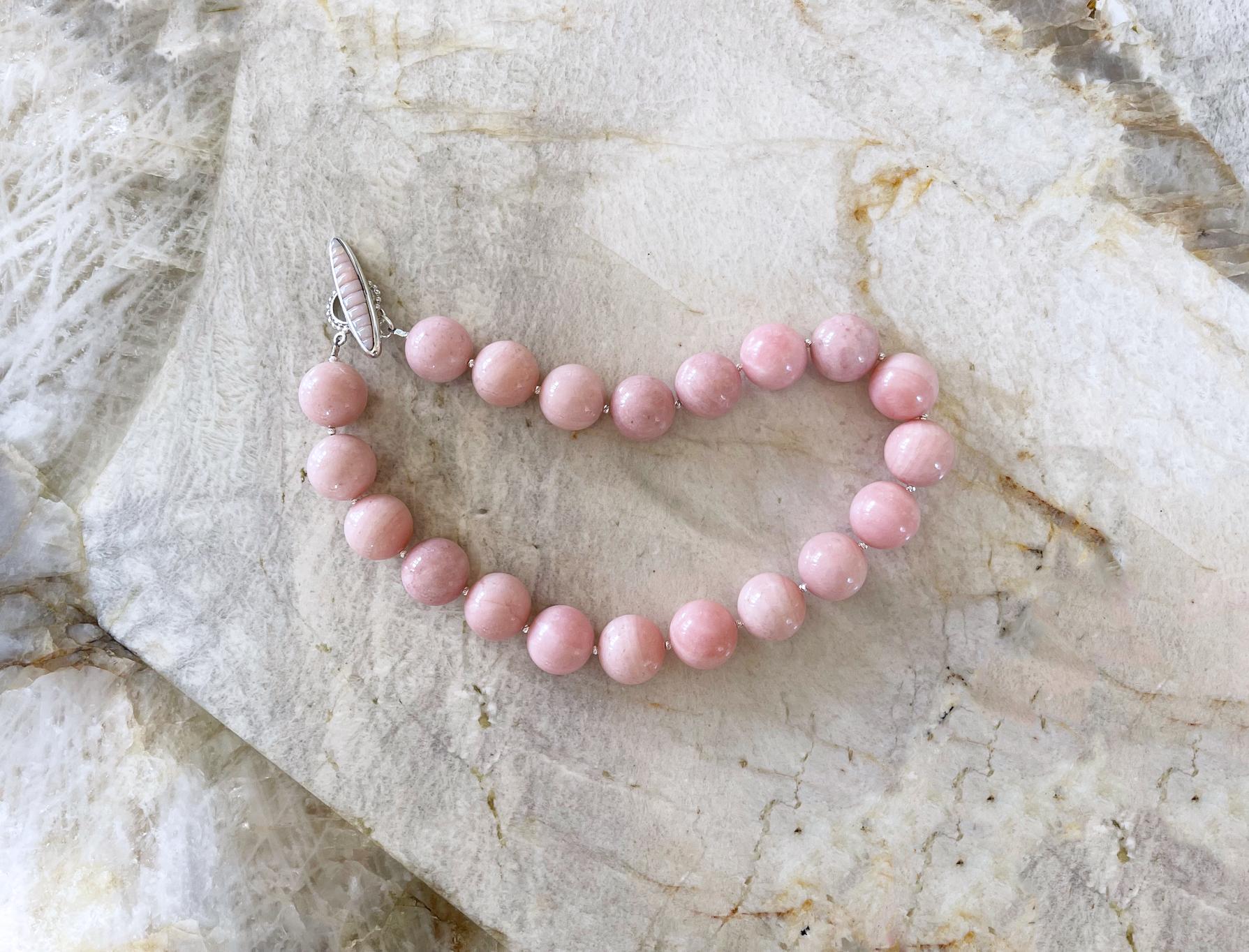 A top quality natural 20mm bubblegum pink Peruvian opal beaded necklace accented with tiny sterling silver beads and finished with a handmade sterling silver toggle clasp with coordinating pink mother of pearl inly. Handcrafted in the USA by Rocat