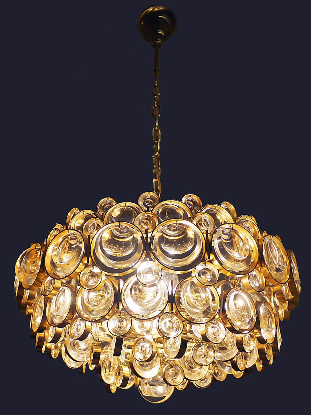 Glamorous vintage multi-tiered bubbles chandelier made of a 24-carat gold-plated brass frame with round crystal prisms and gilt brass rings. Crystal glass resembles Lenses. Designed in the 1960s by Gaetano Sciolari. Manufactured by Palwa (Palme &