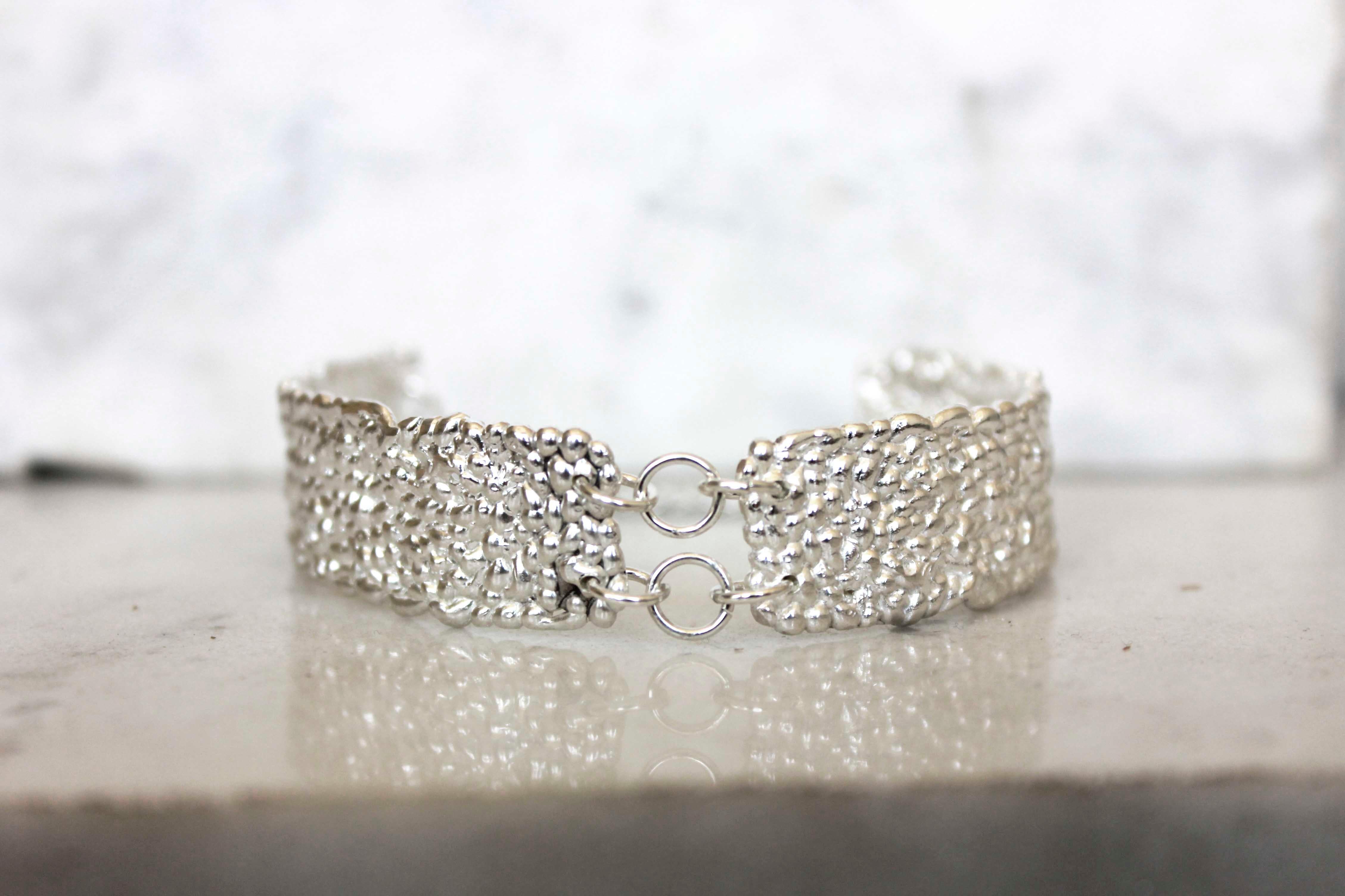 Bubbles chunky bracelet

A chunky silver bracelet with a textured organic feel.

A statement bracelet that is made of little tiny different size droplets in sterling silver that create an incredible sparkle which draw attention.
