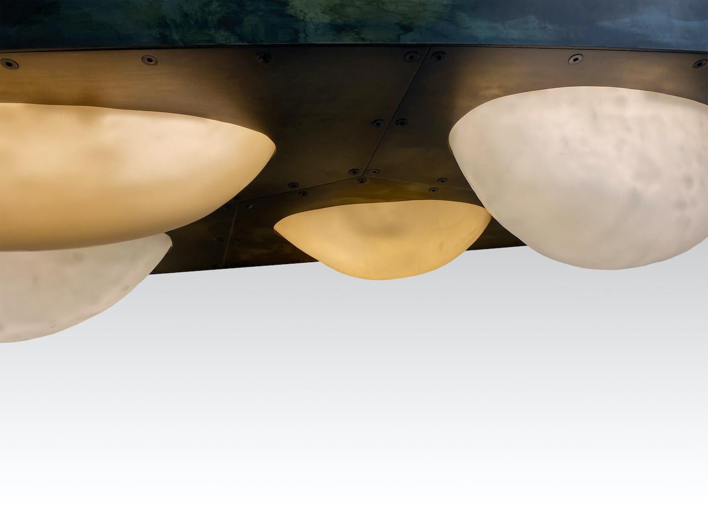 Patinated Bubbles Curved, Patina'ed Brass Chandelier with Illuminated Slumped Glass Forms For Sale