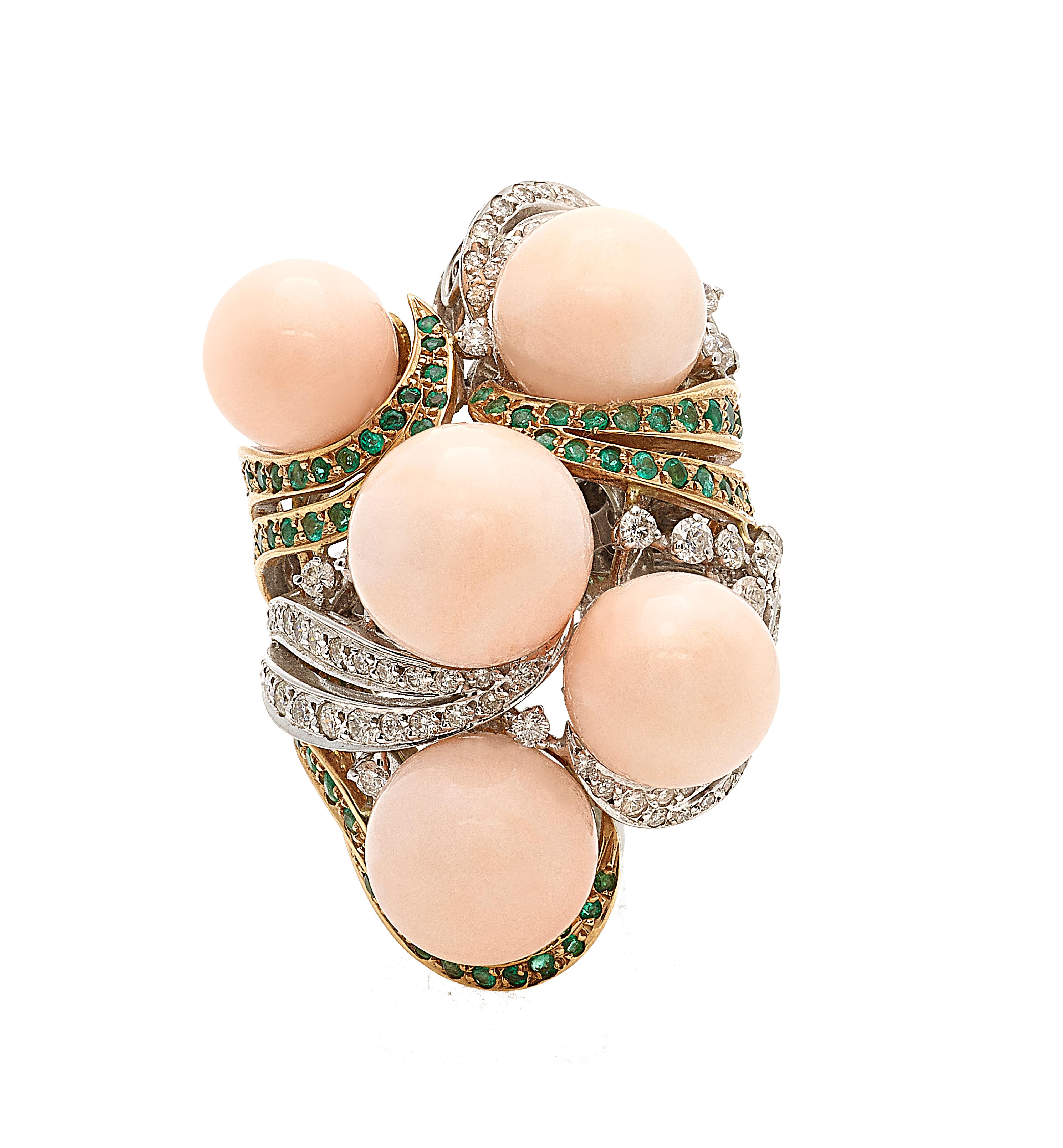 This sculptural ring is stunning handmade creation that suggests the atmosphere of a siren on the rocks. 
With a weight that amount to 51grams of 18kt white and yellow gold,  five spheres of pale pink coral (angel skin) are enveloped on the golden