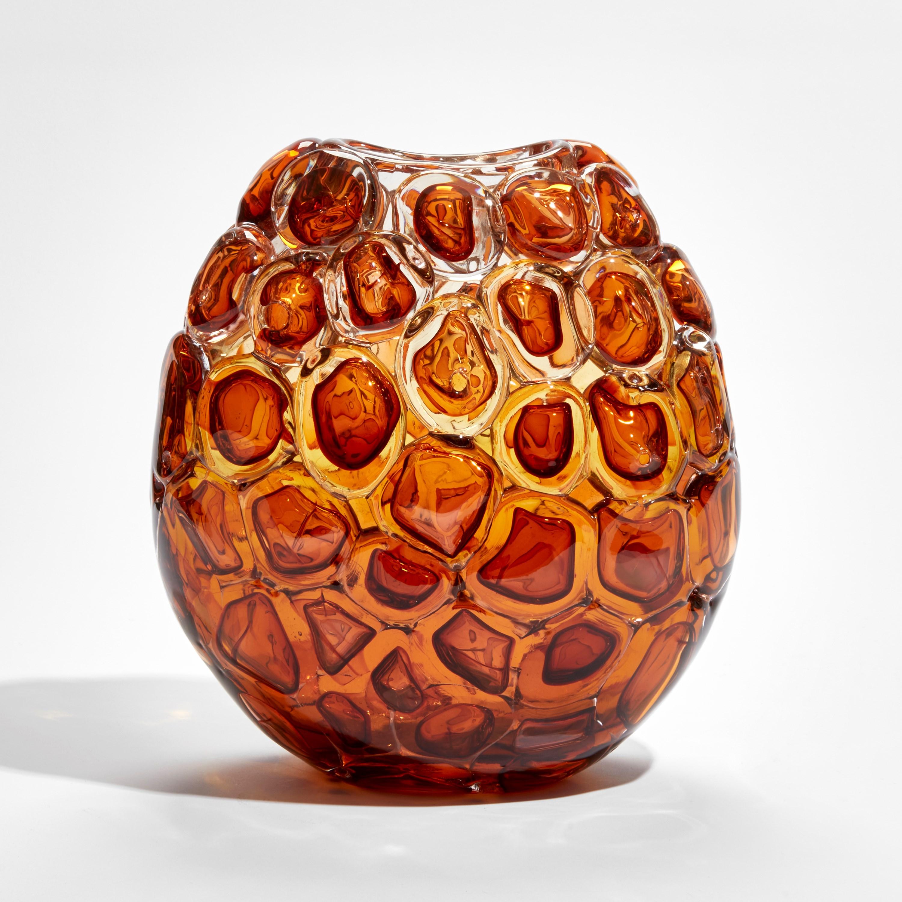 'Bubblewrap in Burnt Orange' is a handblown and sculpted vase created from rich amber / orange coloured glass by the British artist, Allister Malcolm. Playful yet elegant, Malcolm has formed oversized bubbles on the exterior of this handcrafted and
